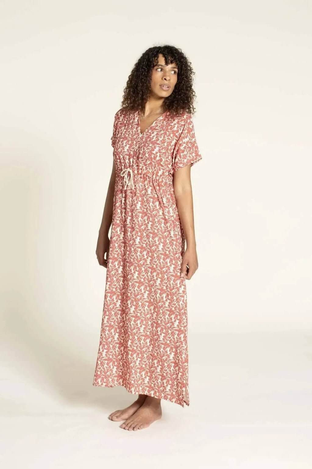 Model wearing the Abby Dress sewing pattern, a kaftan-style dress with a deep V-neckline and Dolman sleeves.