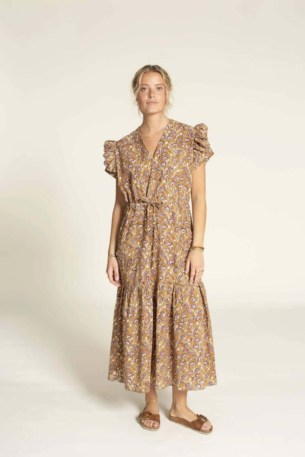 Model wearing the Abby Dress sewing pattern, showcasing a relaxed kaftan style with ruffles and a deep V-neckline.