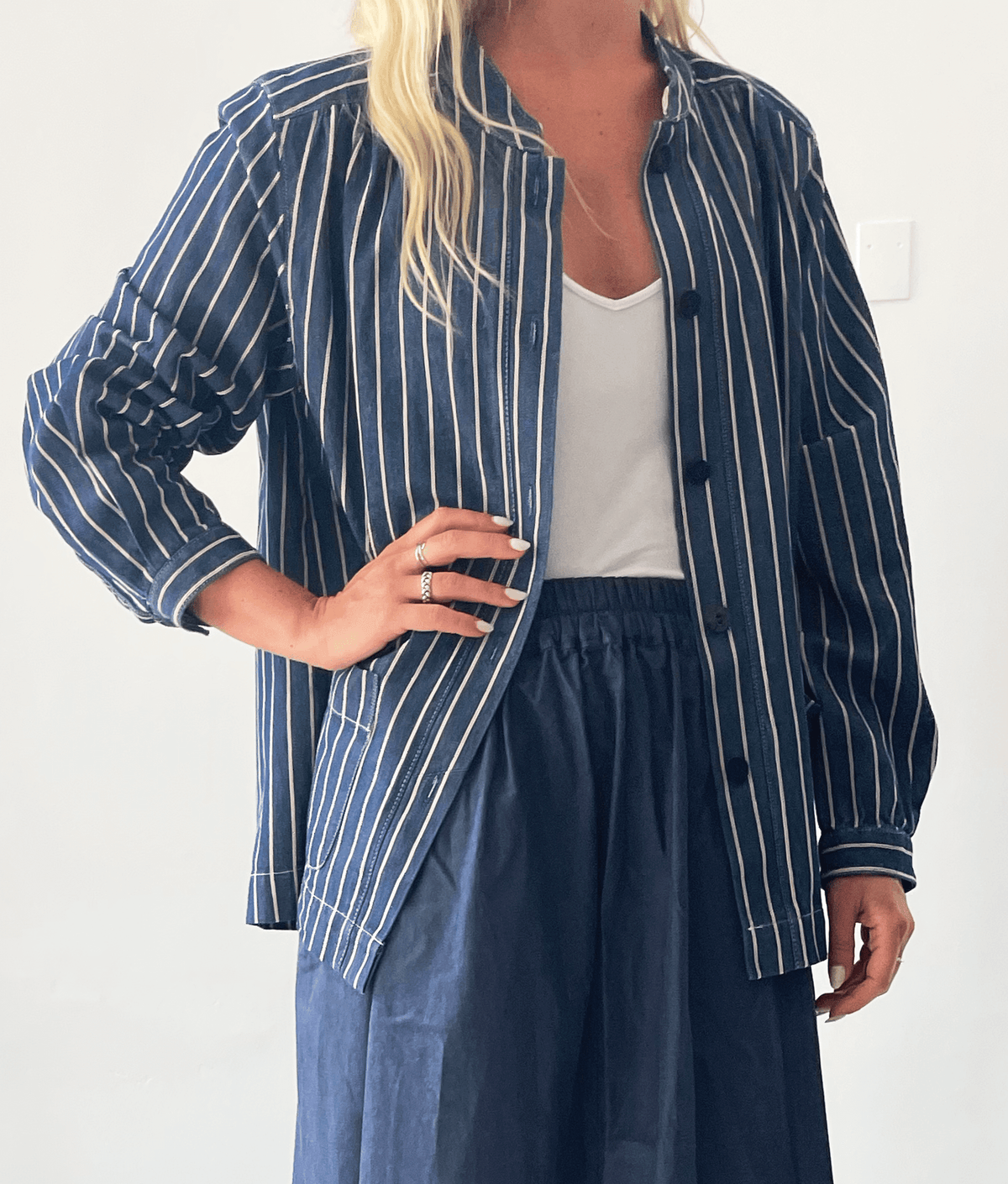 Model wearing the Artist Jacket Paper Pattern, a relaxed striped jacket with dropped shoulders and front-button placket.