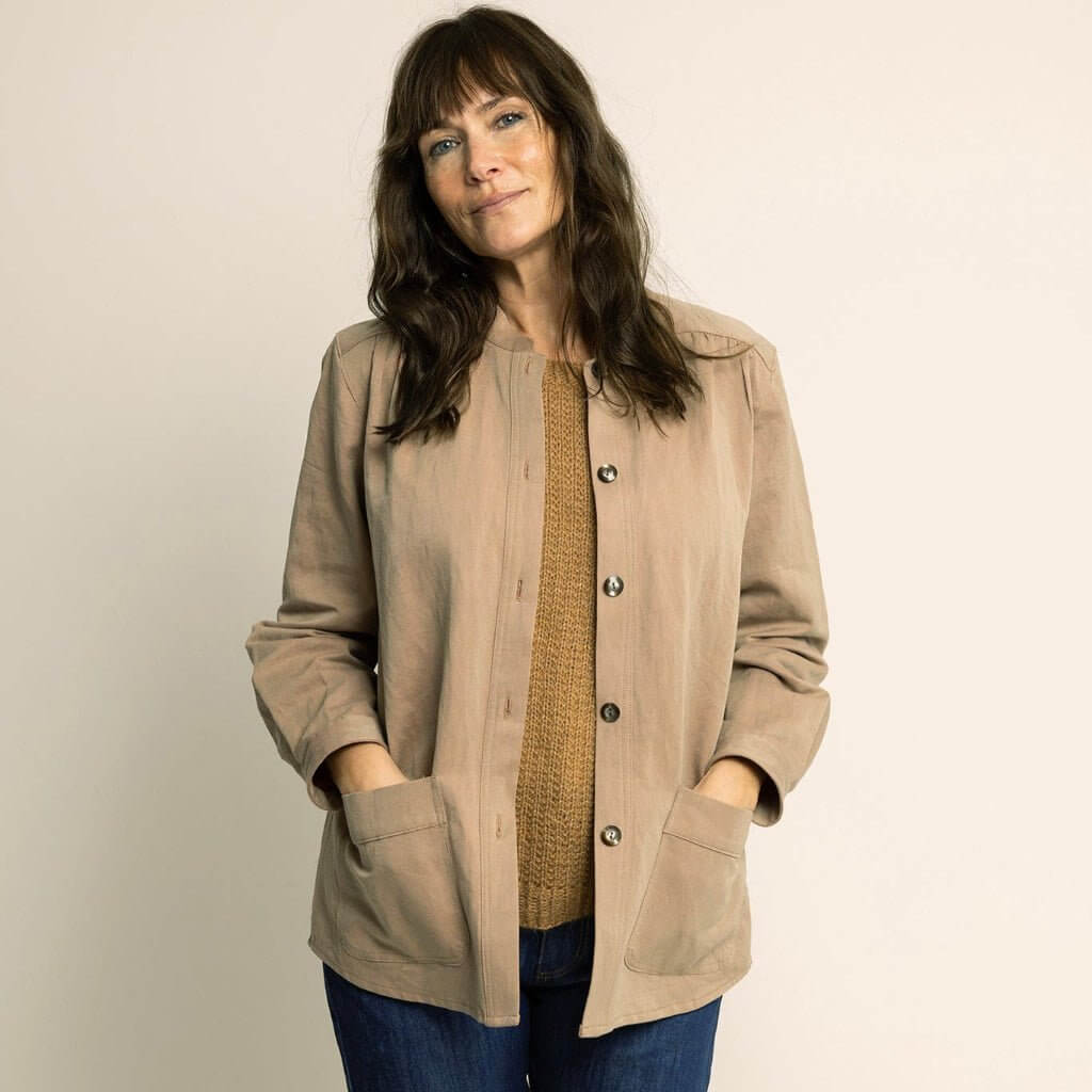 Woman wearing a relaxed Artist Jacket Paper Pattern in beige with patch pockets and front-button placket.