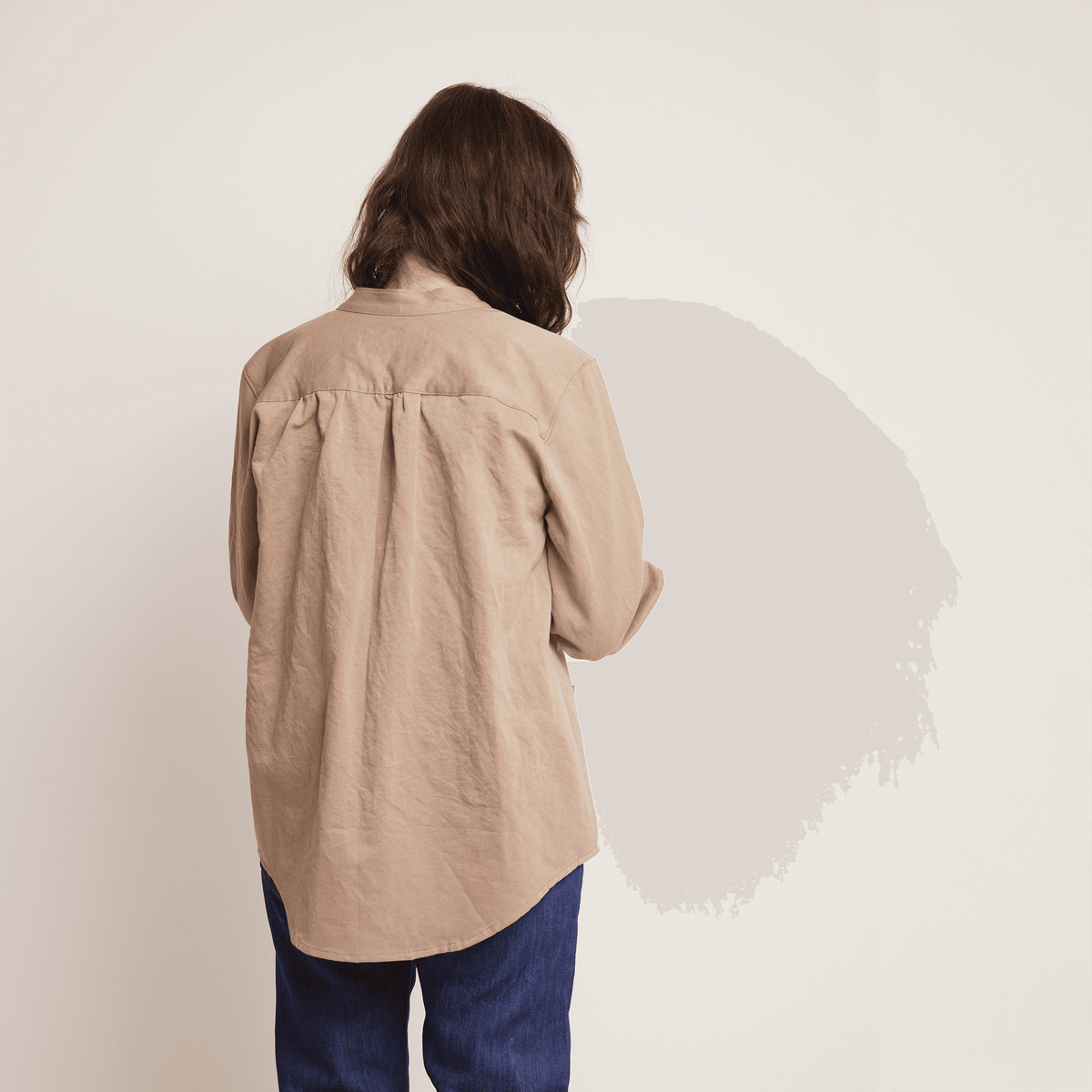 Back view of a woman wearing the Artist Jacket Paper Pattern, showcasing its relaxed fit and minimalist design.