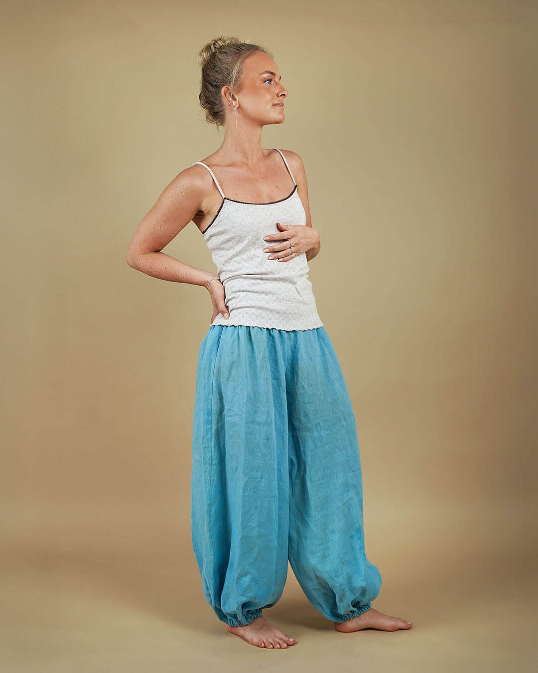 Model wearing lightweight Bubble Pants sewing pattern, showcasing voluminous legs in playful blue fabric.