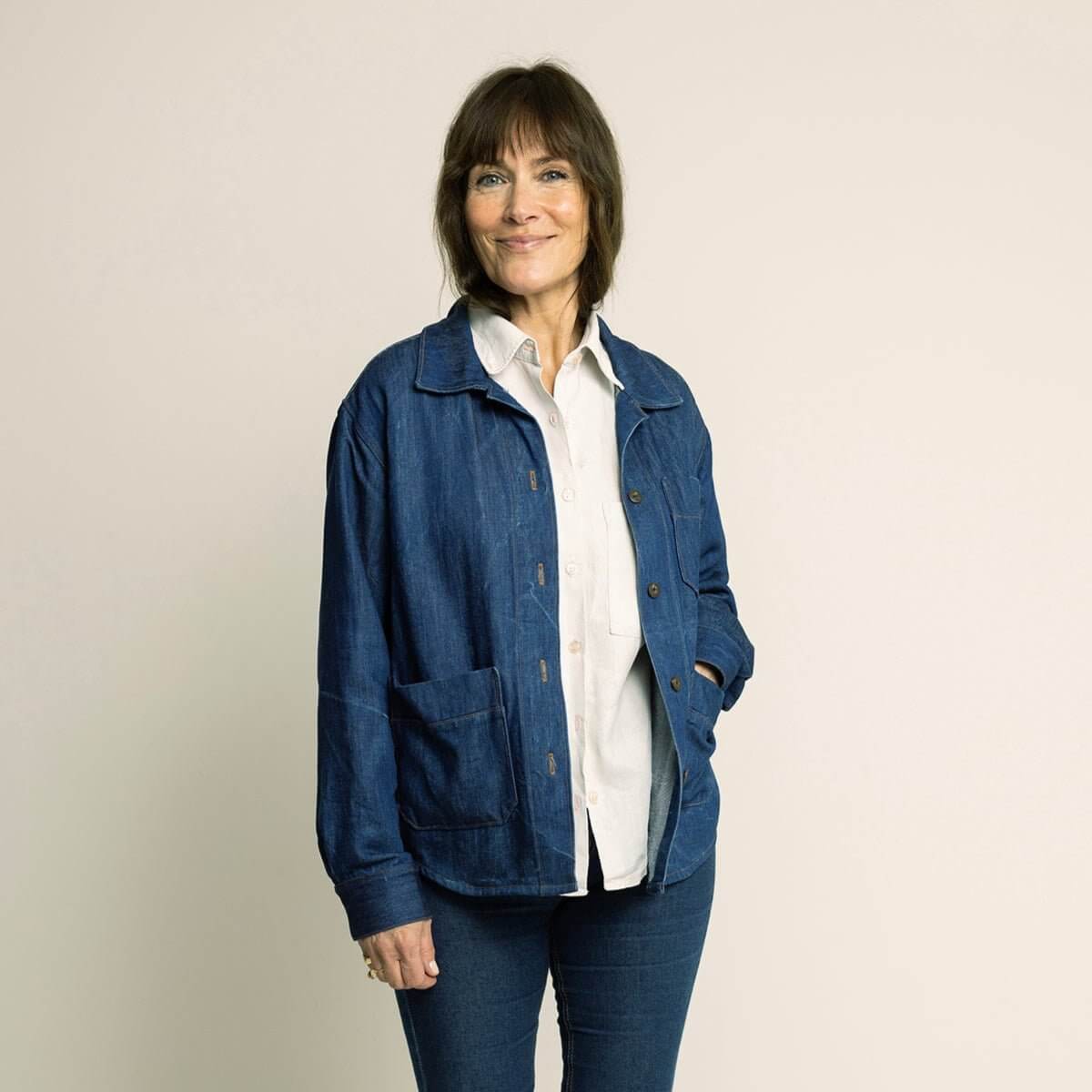 Woman wearing a Canvas Jacket Paper Pattern, a blue casual jacket with pockets, styled with a white shirt.