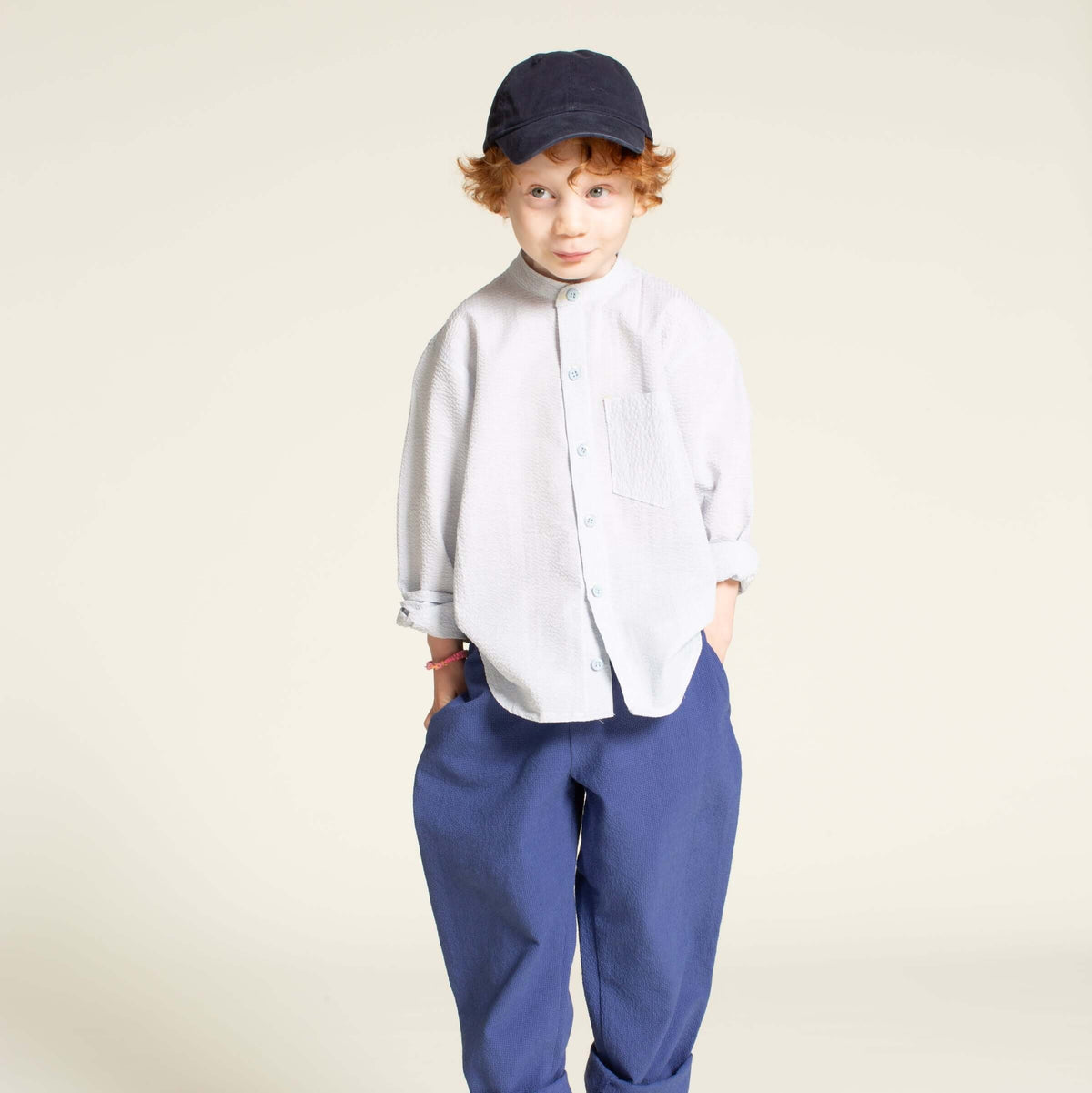 Boy wearing the Mini Jensen Shirt sewing pattern in a relaxed fit with a banded collar and pocket.