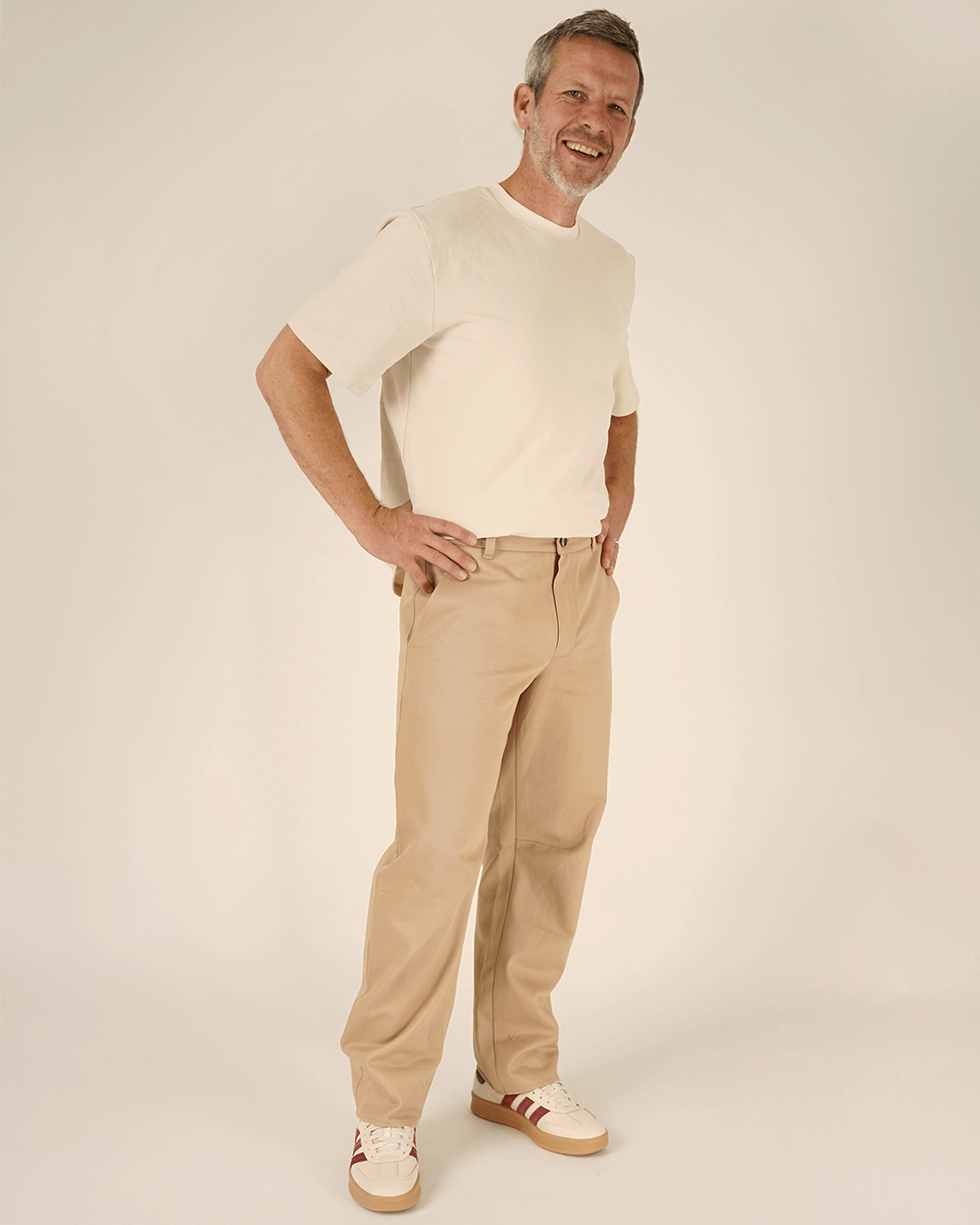 Man wearing Barrel Chino Pants sewing pattern with a white shirt and sneakers, showcasing a modern style.