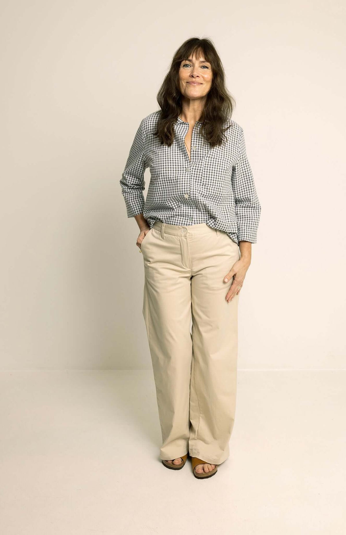 Model wearing Hepburn Pants Paper Pattern with a stylish blouse, showcasing comfort and sophistication.