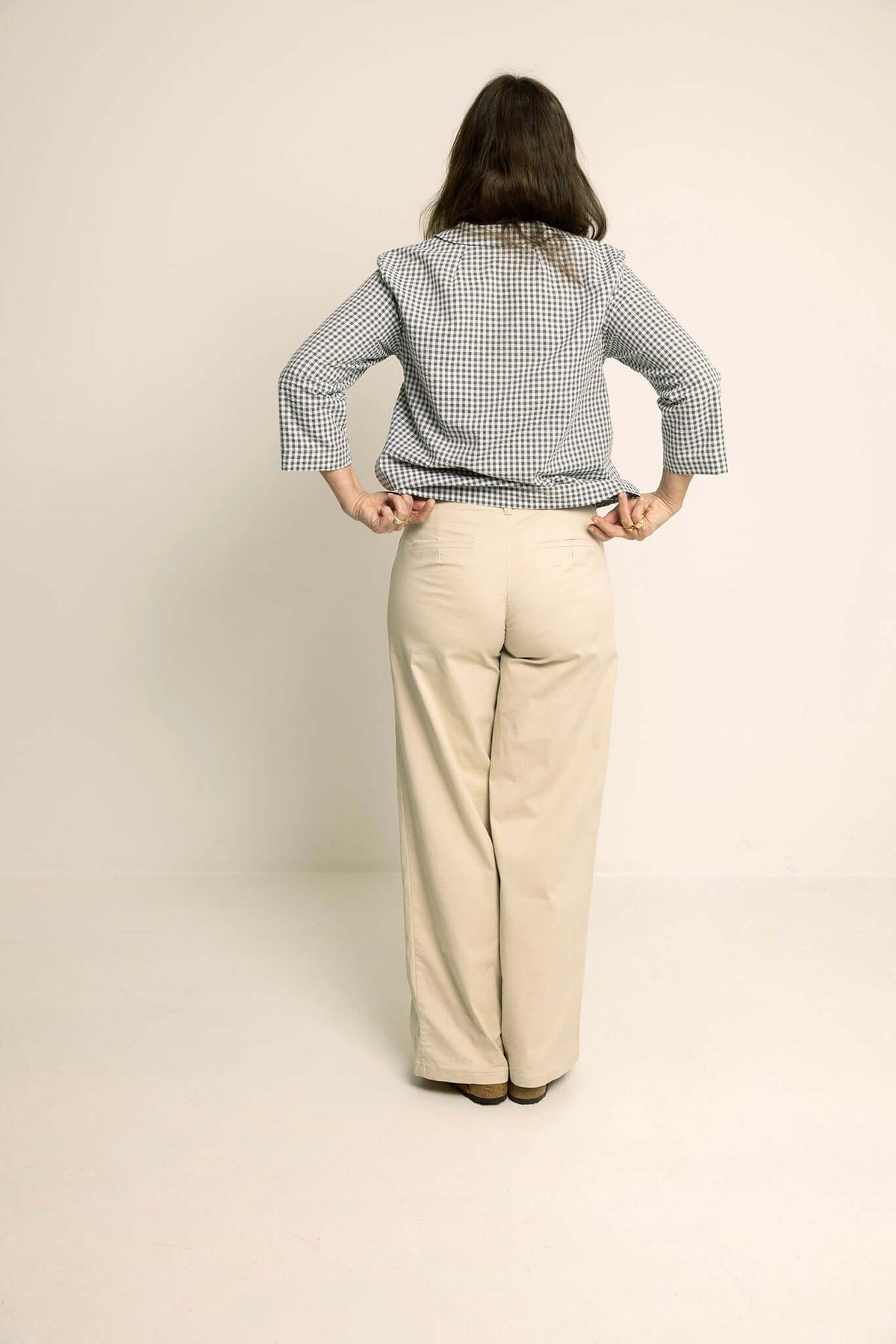 Model wearing Hepburn Pants Paper Pattern, showcasing the back view with a fitted waist and wide-leg design.