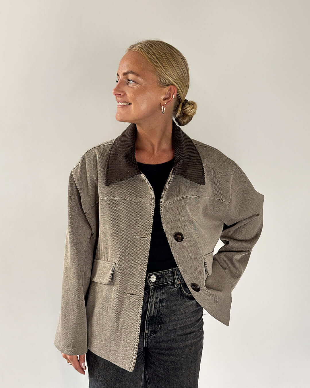 Model wearing a stylish Car Coat Sewing Pattern in a cozy fabric, paired with jeans and a black top, showcasing modern outerwear.