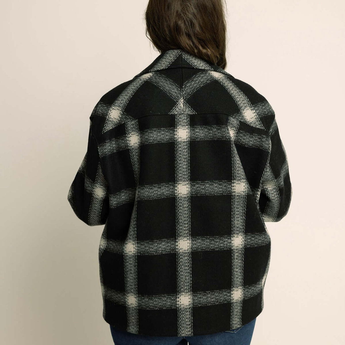 Back view of a relaxed fit Car Coat Sewing Pattern with a plaid design, ideal for layering and stylish outerwear.