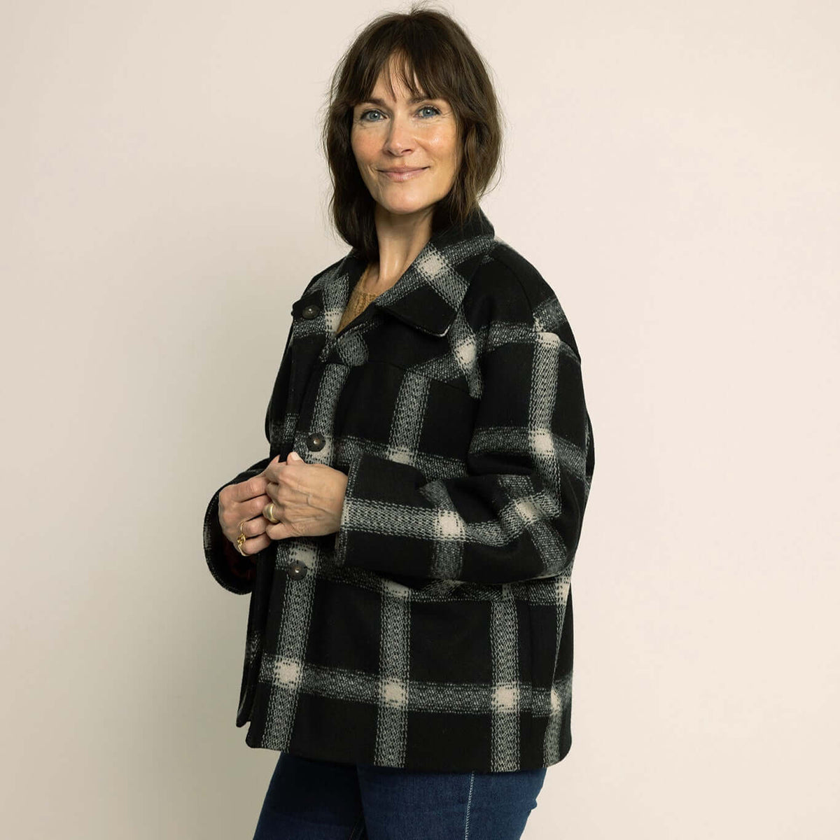 Model wearing a stylish black and white plaid Car Coat Sewing Pattern, showcasing relaxed outerwear style.