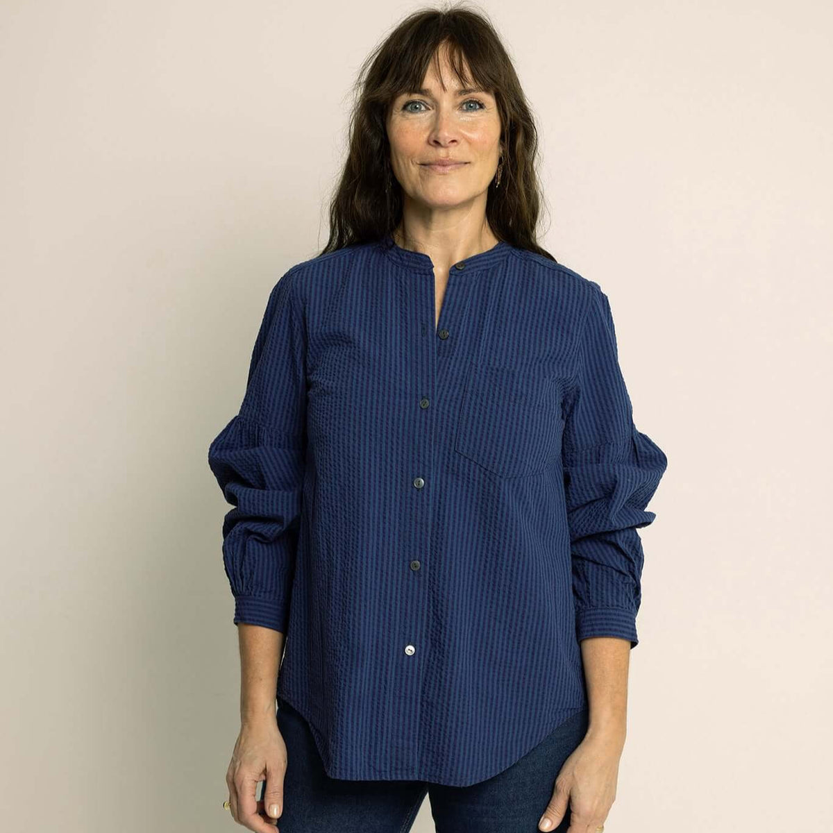 Puff Shirt Paper Pattern model wearing a stylish navy blue blouse with elegant gathering details.