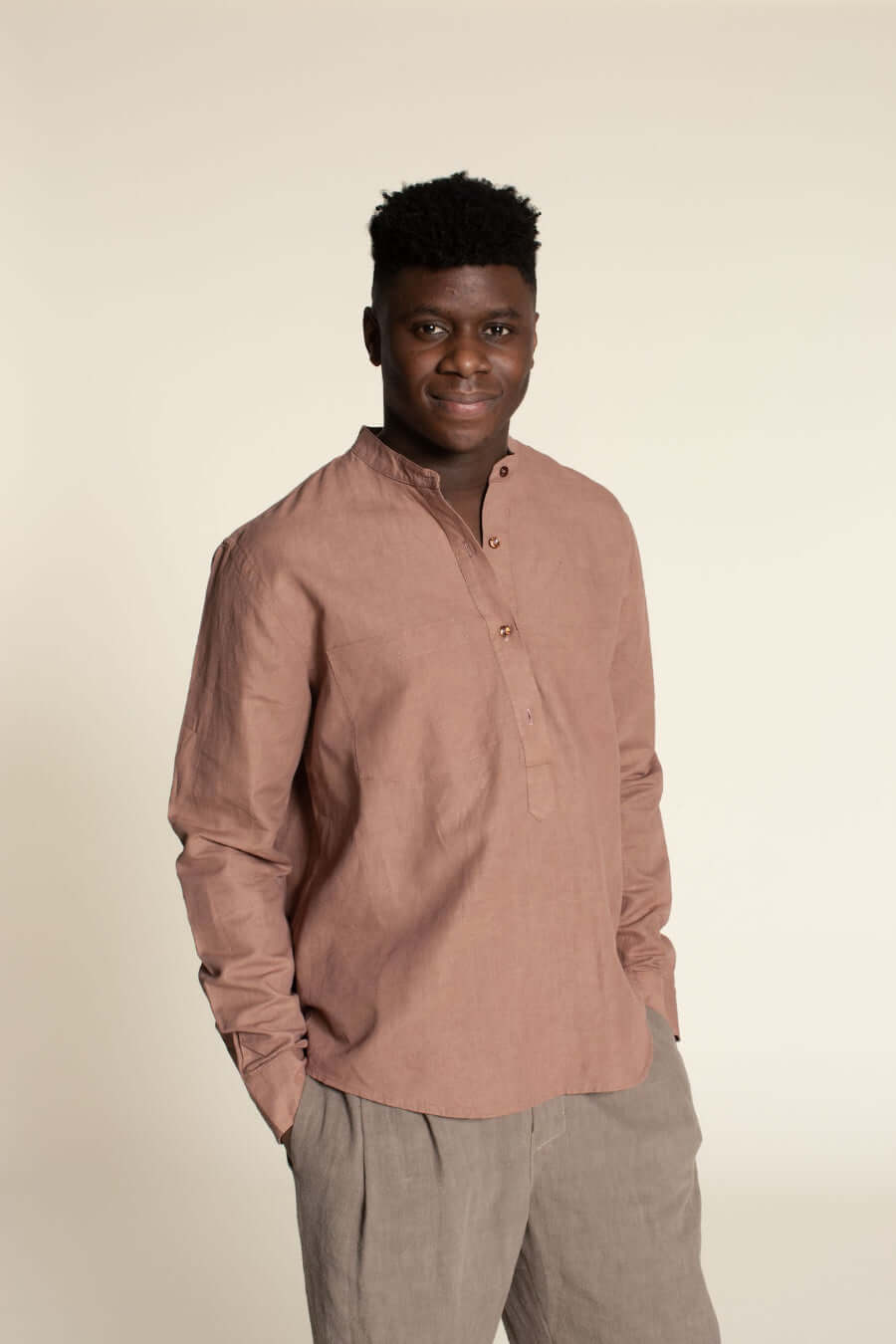 Men's Tunic paper pattern model wearing a pink banded collar tunic with four-button front placket.