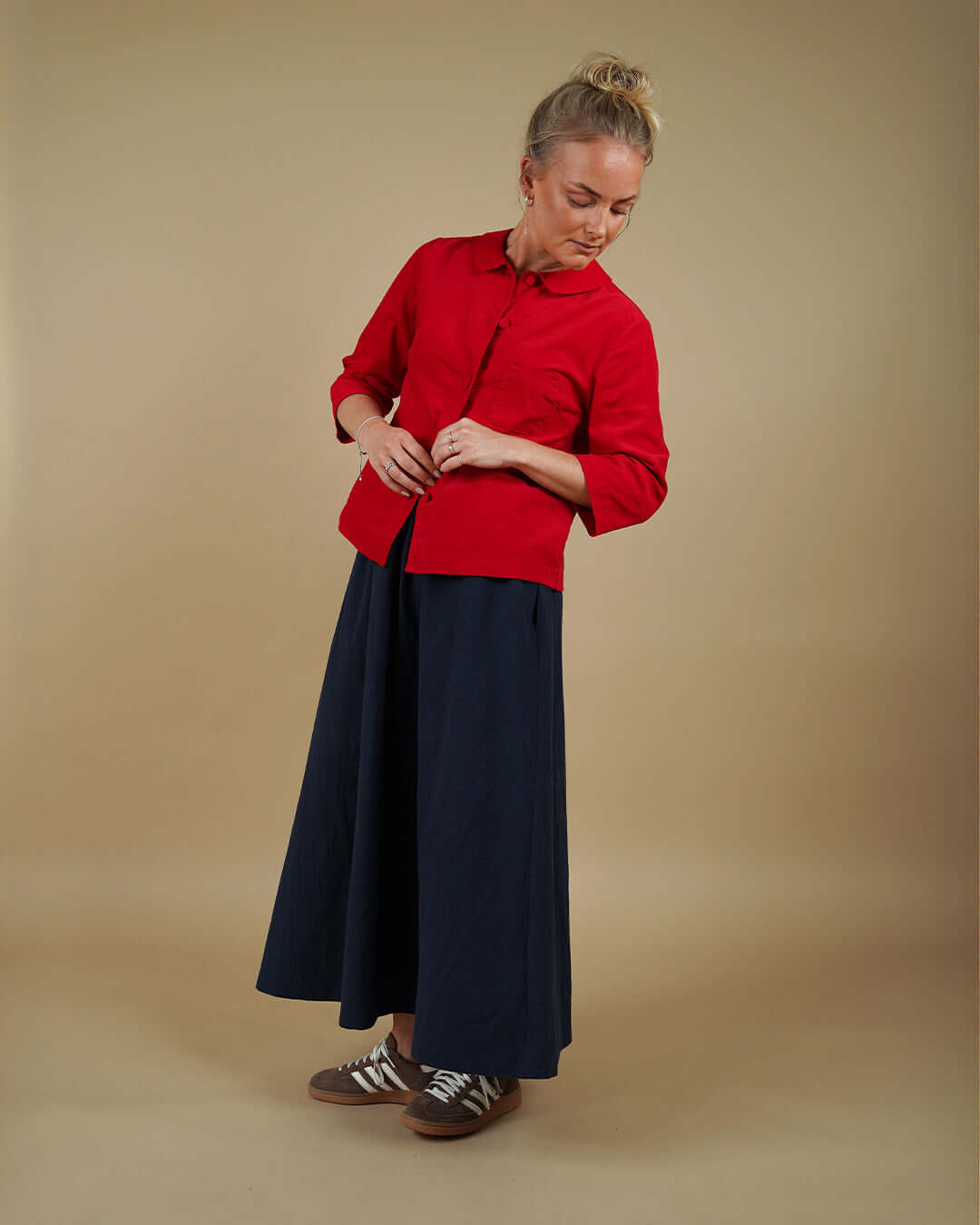 Woman wearing the Dukke Blouse and Claude Skirt sewing pattern, front view
