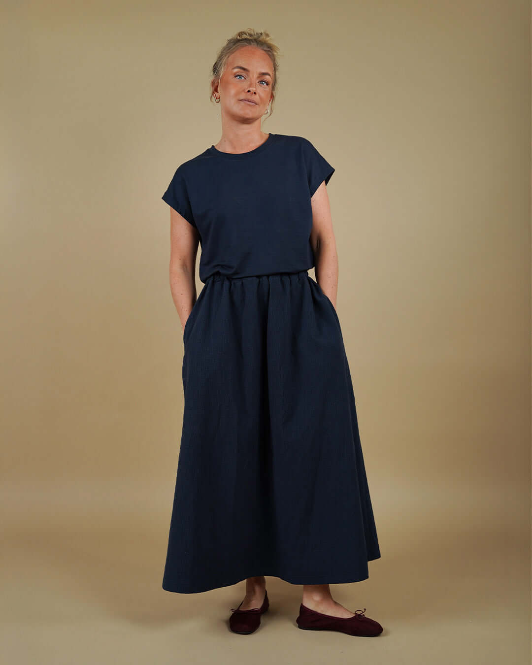 Woman wearing the Easy Tee and Claude Skirt sewing pattern, front view