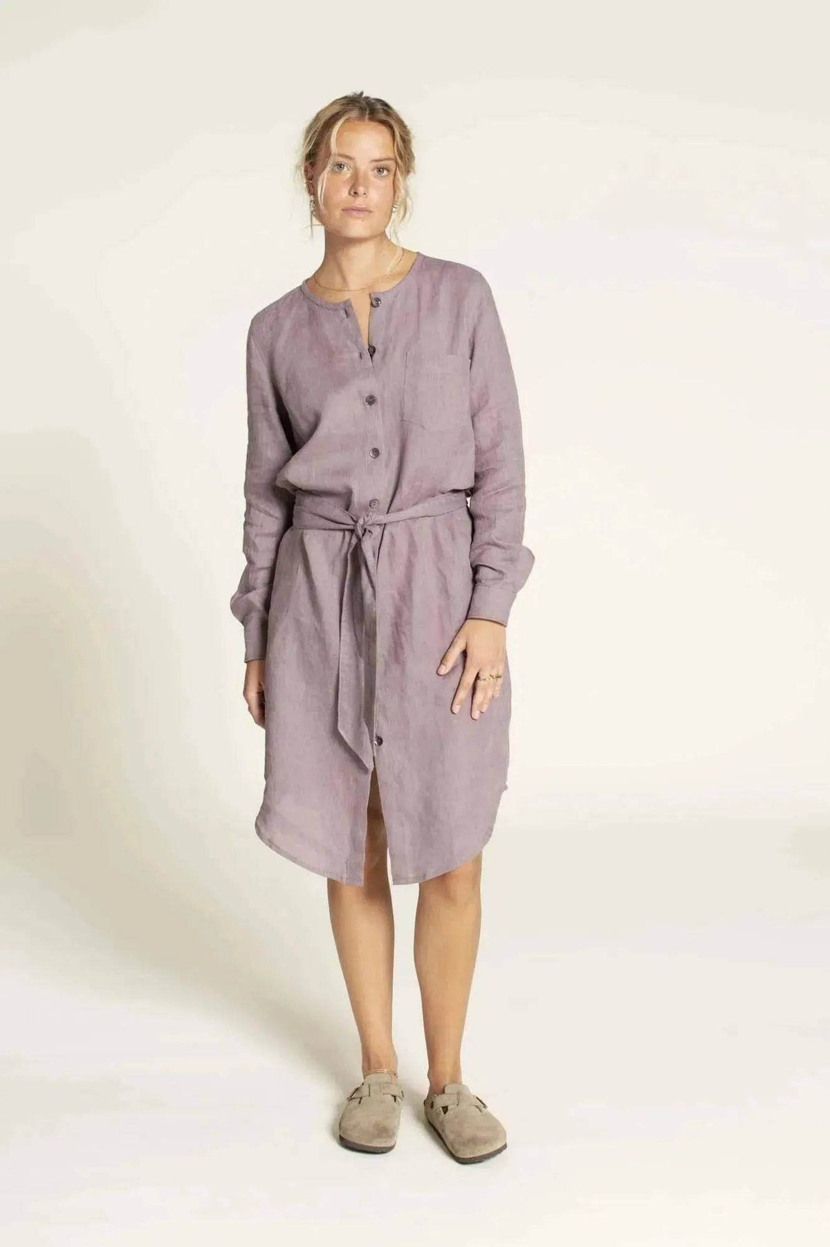 Savannah shirt Paper Pattern model wearing a mauve belted shirtdress with buttons and long sleeves.