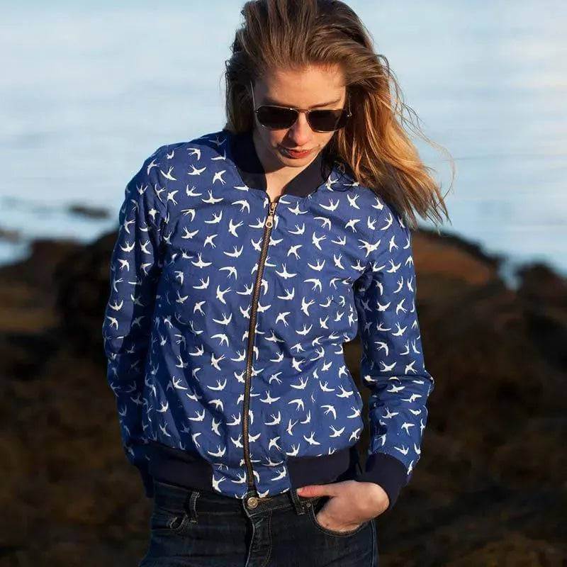 Bomber Jacket Paper Pattern worn by a woman, showcasing a stylish floral design and sporty silhouette with zipper.