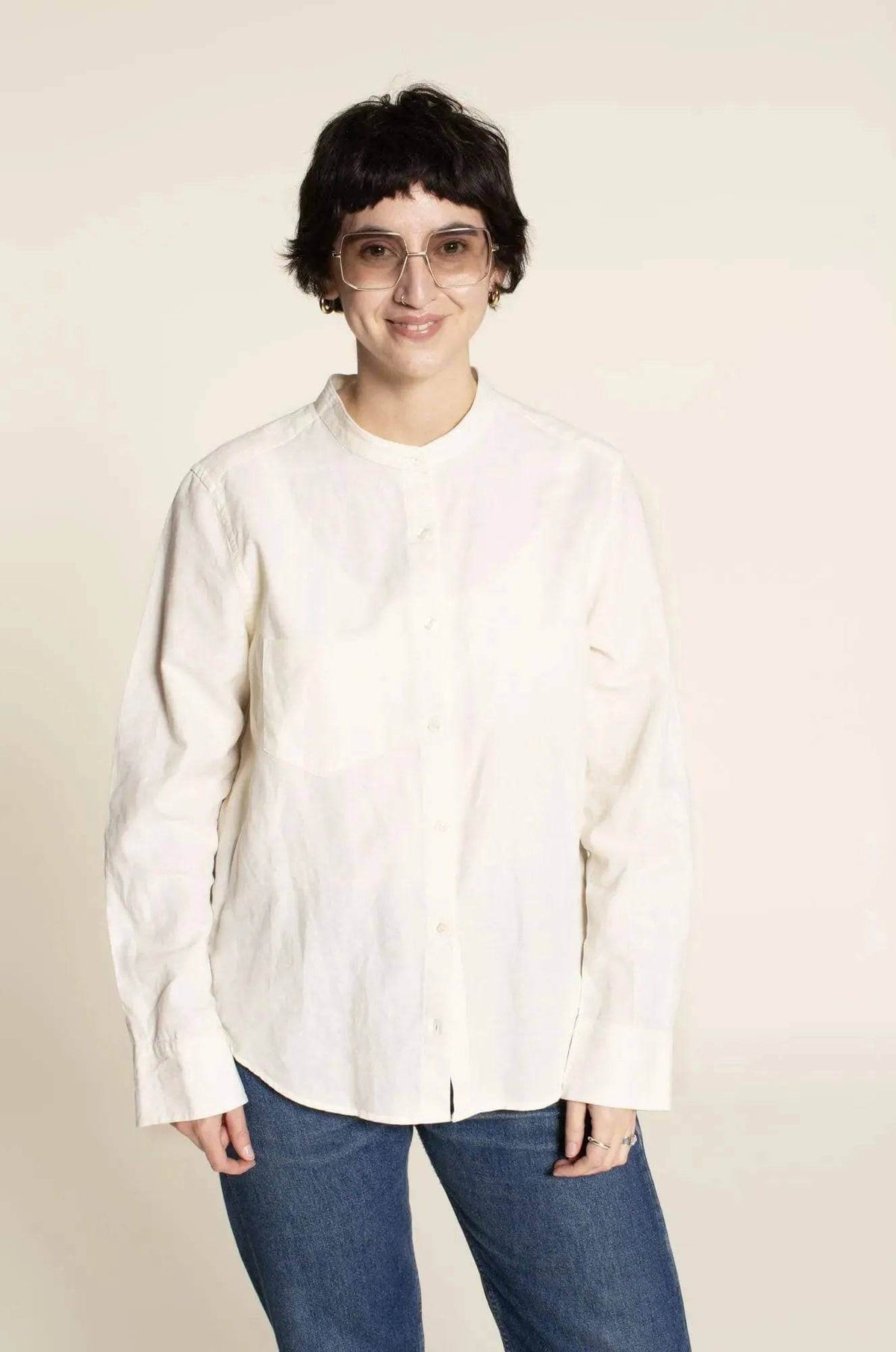 Anna Shirt Paper Pattern model wearing a classic white long-sleeve shirt, showcasing women's fashion styles.