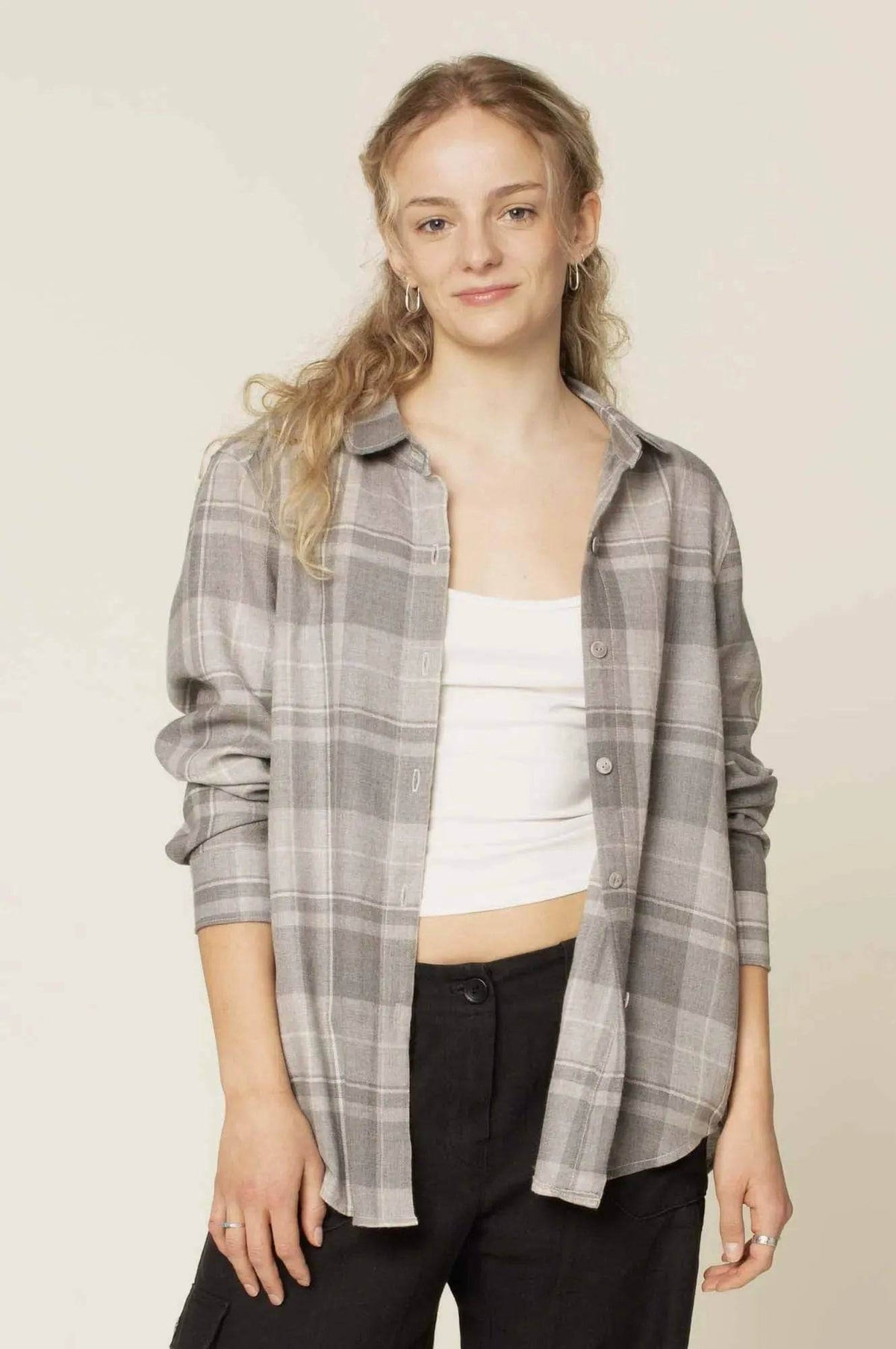 Woman wearing Anna Shirt Paper Pattern in a gray checkered design with a casual look.