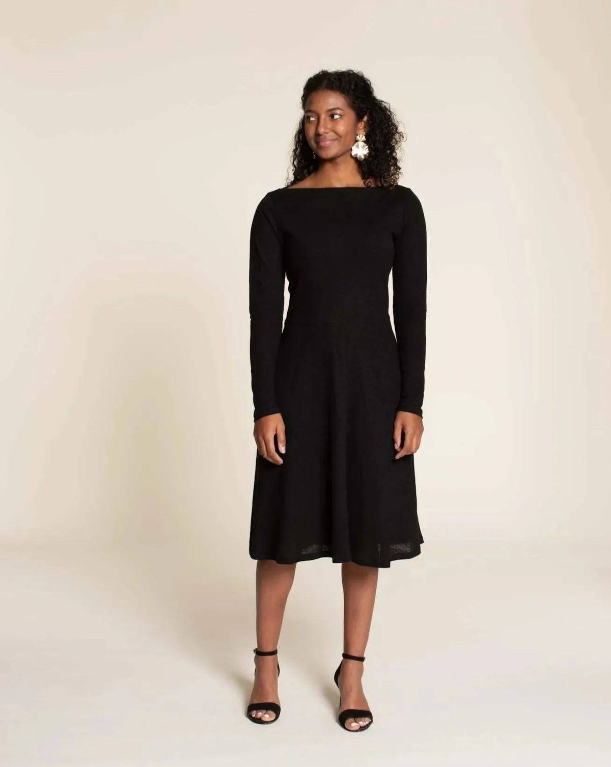 Asta dress Paper Pattern worn by model, featuring a fitted bodice and semi-circular A-line skirt in black.