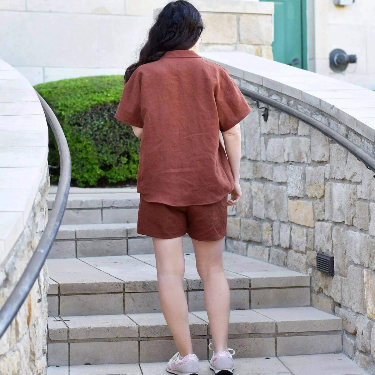 Camp Shirt and shorts Paper Pattern displayed on a model walking up stairs, showcasing the stylish outfit.