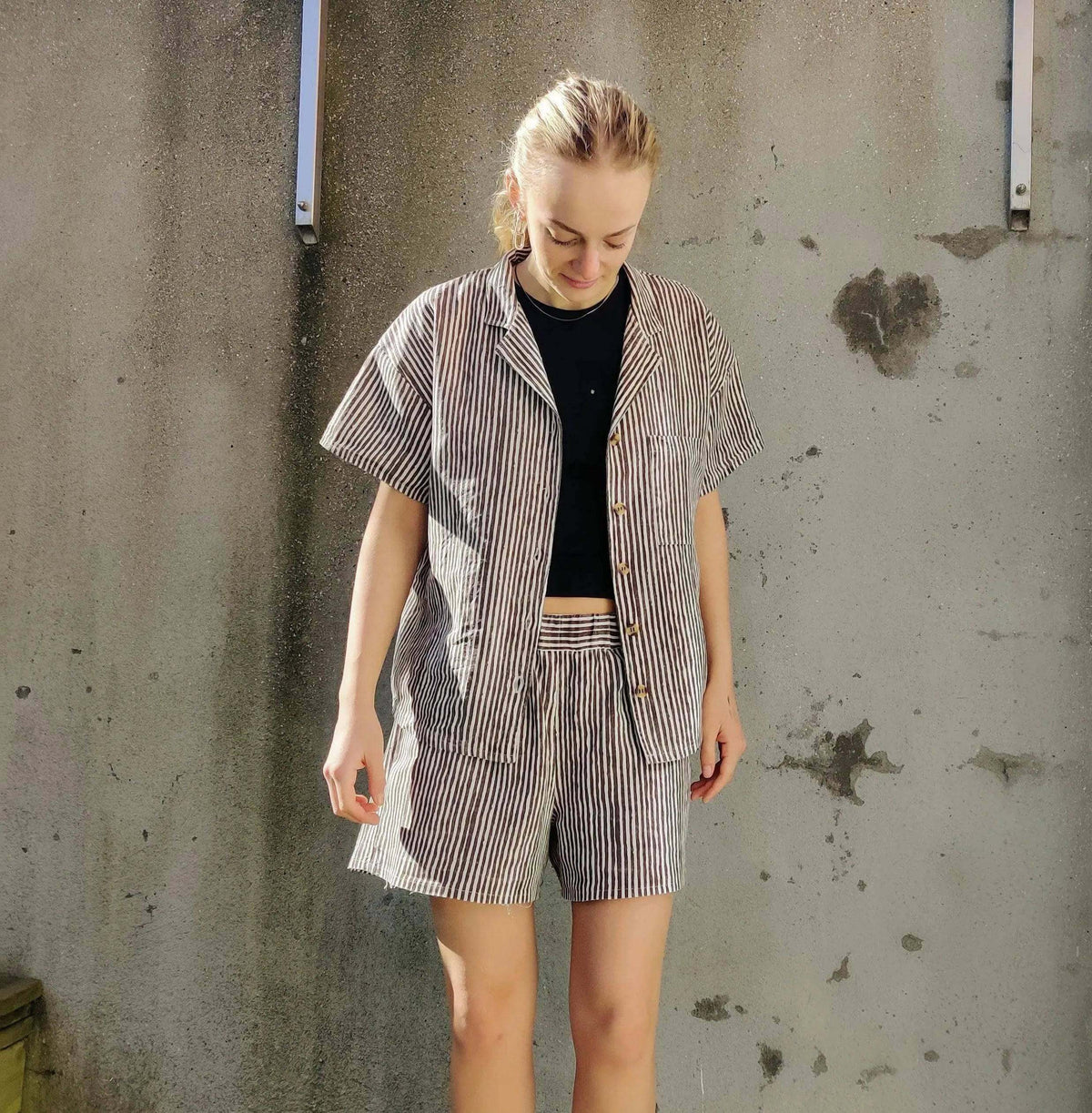 Model wearing Camp Shirt and shorts Paper Pattern in striped fabric, showcasing a relaxed style and comfortable fit.
