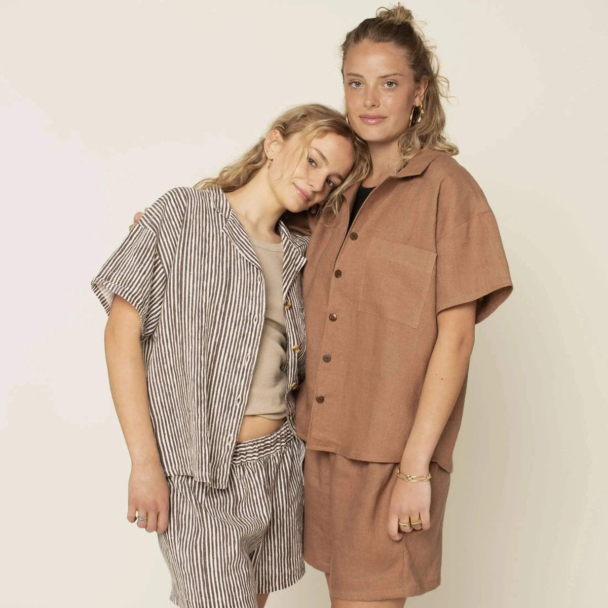 Two models wearing outfits made from Camp Shirt and shorts Paper Pattern, featuring a boxy shirt and roomy shorts.