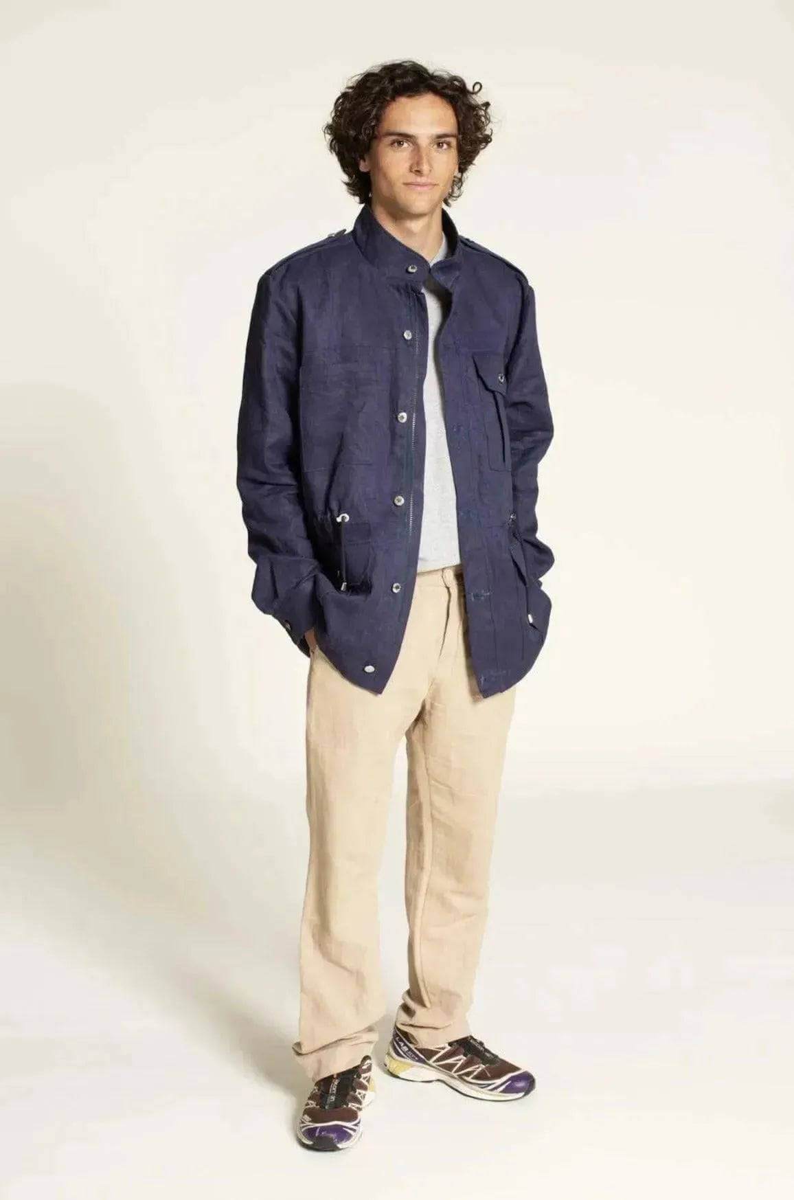 Young man wearing a navy jacket with Chino Pants Paper Pattern in a stylish pose.