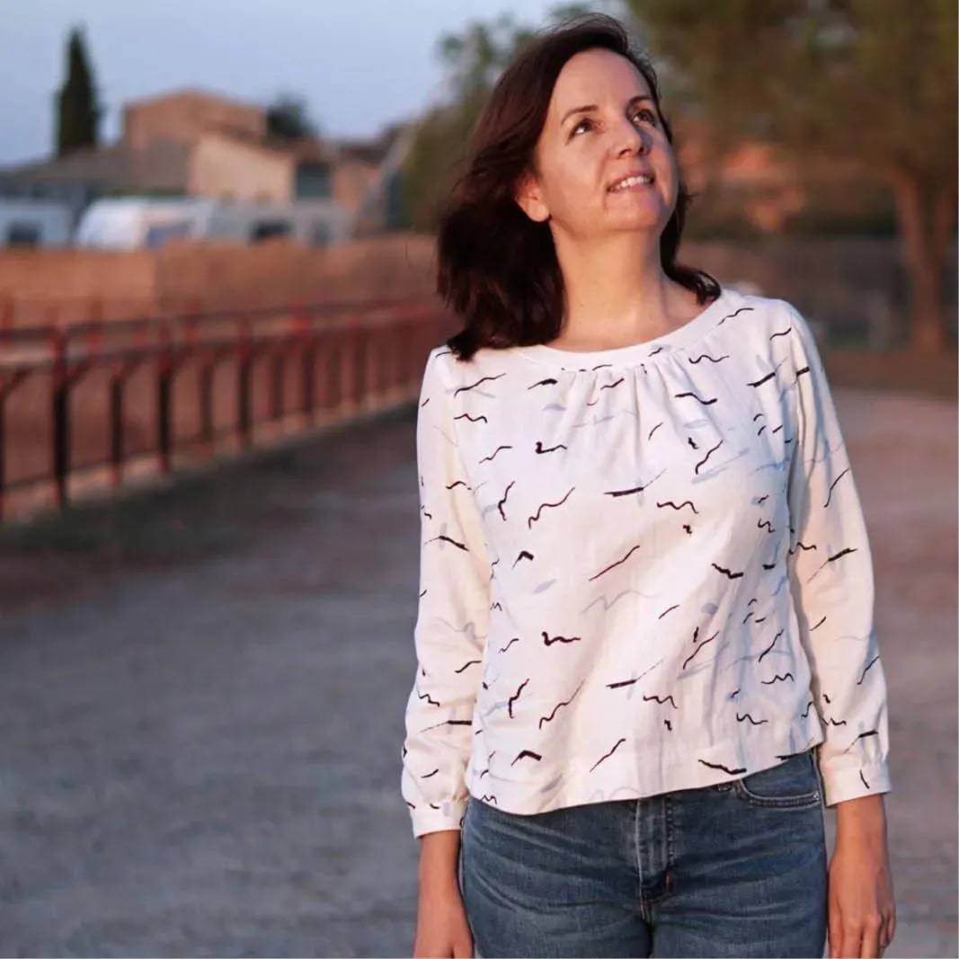 Woman wearing Esther Blouse Paper Pattern, delightfully designed top with pleats and gathers.