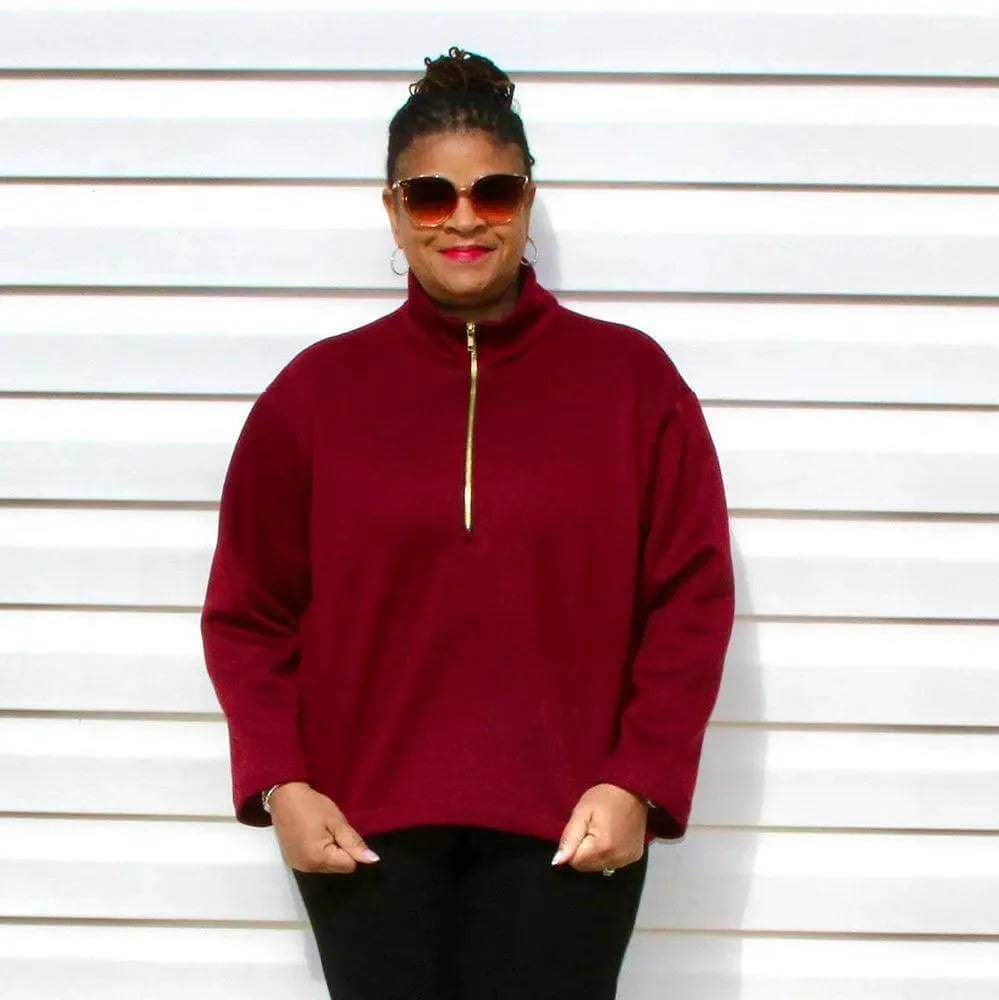 Half-Zipper Sweater Paper Pattern in burgundy with a stand-up collar, modeled by a woman wearing sunglasses.