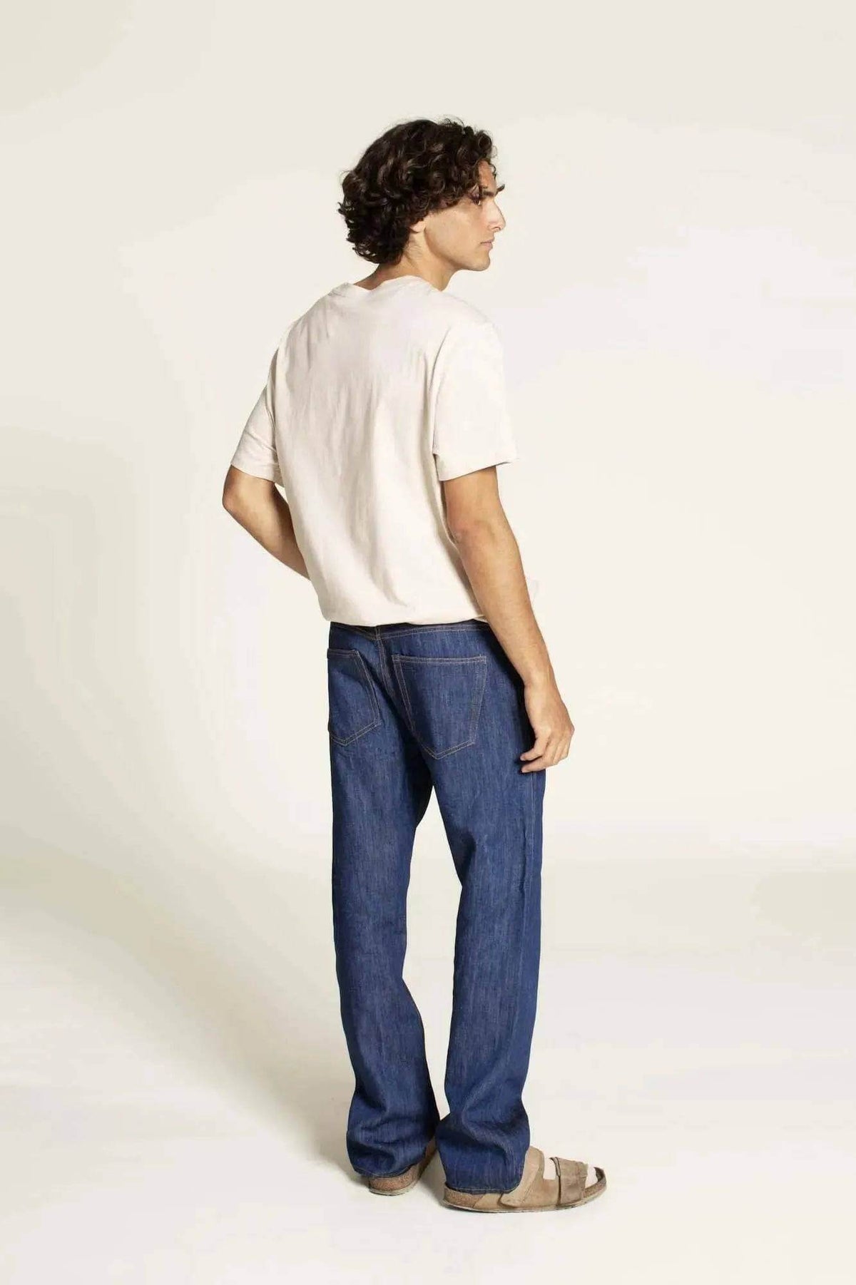 Man wearing Men's Jeans Paper Pattern standing with a casual look, showcasing the fit and style of the jeans.
