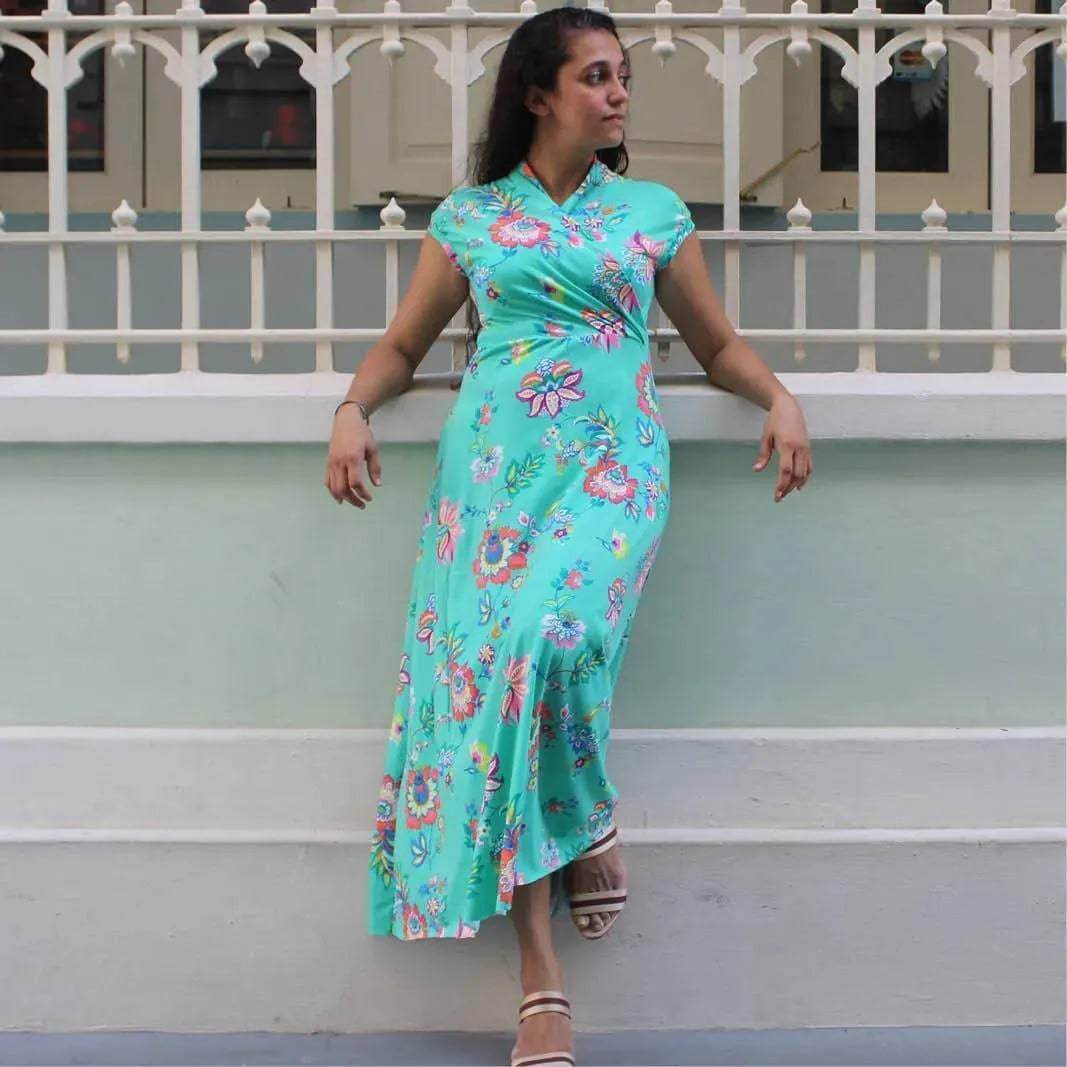 Woman wearing the Mirri Dress Paper Pattern in a floral print, showcasing its flattering A-line design and shawl collar.