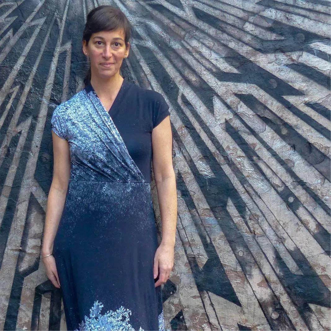 Model wearing the Mirri Dress Paper Pattern against a geometric mural background.