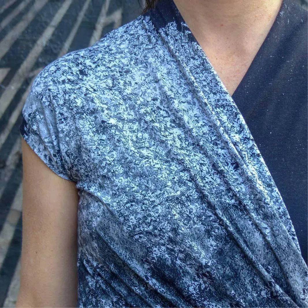 Close-up of Mirri Dress Paper Pattern fabric showcasing a textured blue design with a classic wrap style.