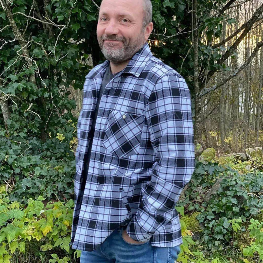 Overshirt Jacket Paper Pattern, a man wearing a plaid shirt jacket with pockets in a natural setting.