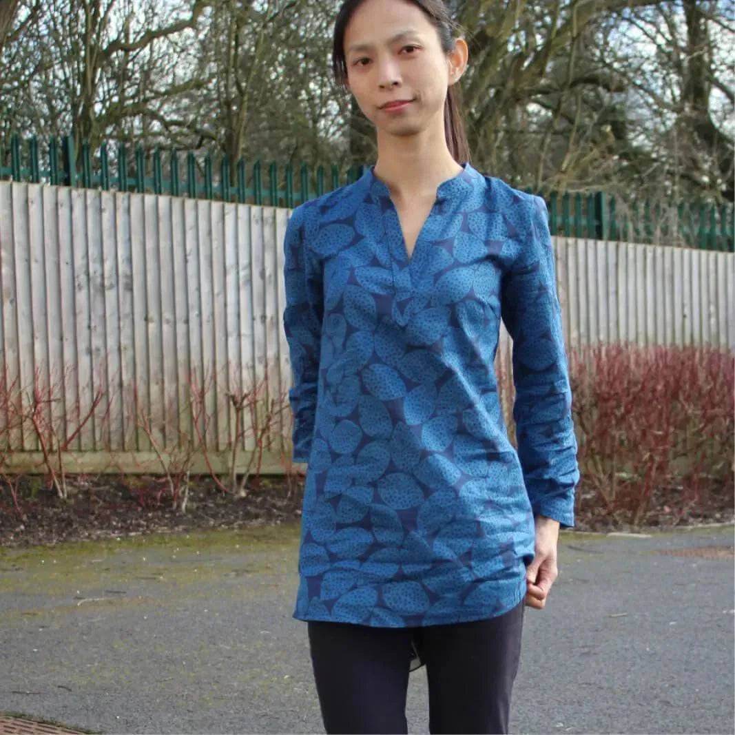 Woman wearing a blue patterned tunic showcasing the Perfect Tunic Paper Pattern design outdoors.