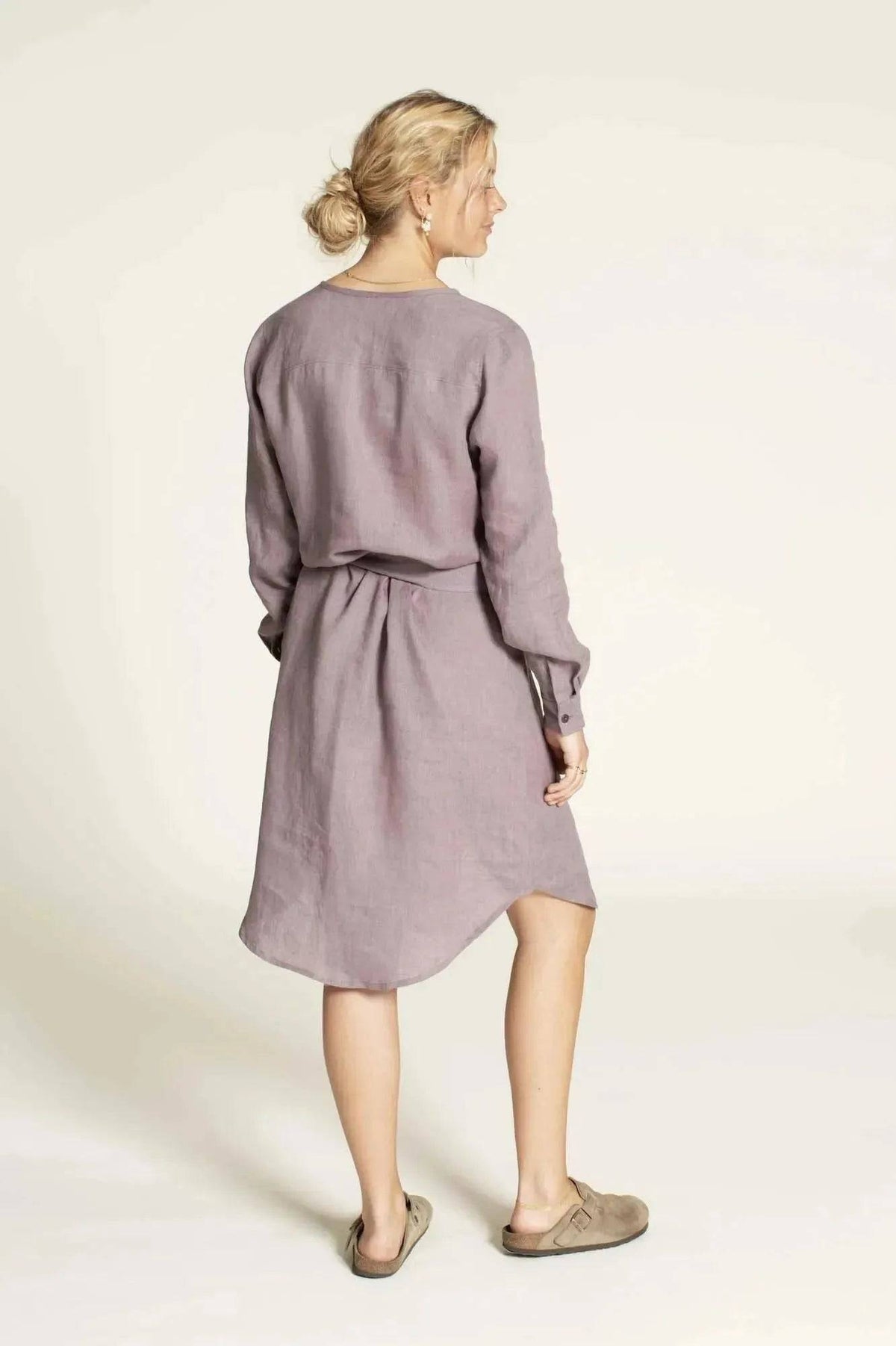 Woman wearing the Savannah shirt Paper Pattern in a lilac hue, showcasing the back view and stylish design.