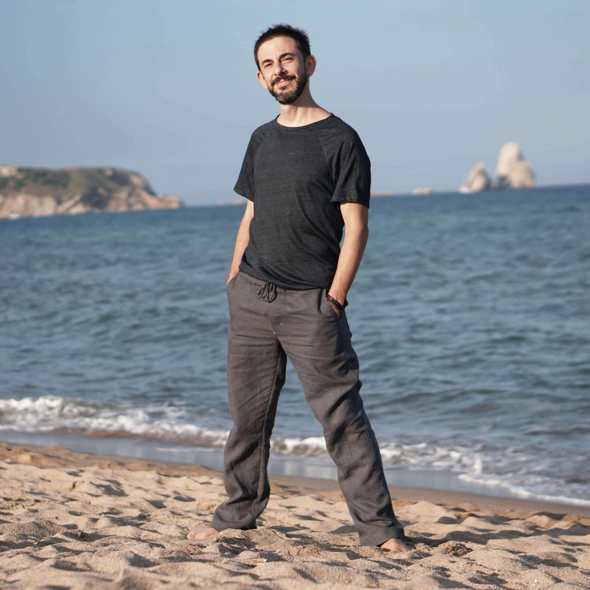Man wearing comfortable pants at the beach, showcasing the Summer pants paper pattern in a relaxed fit.