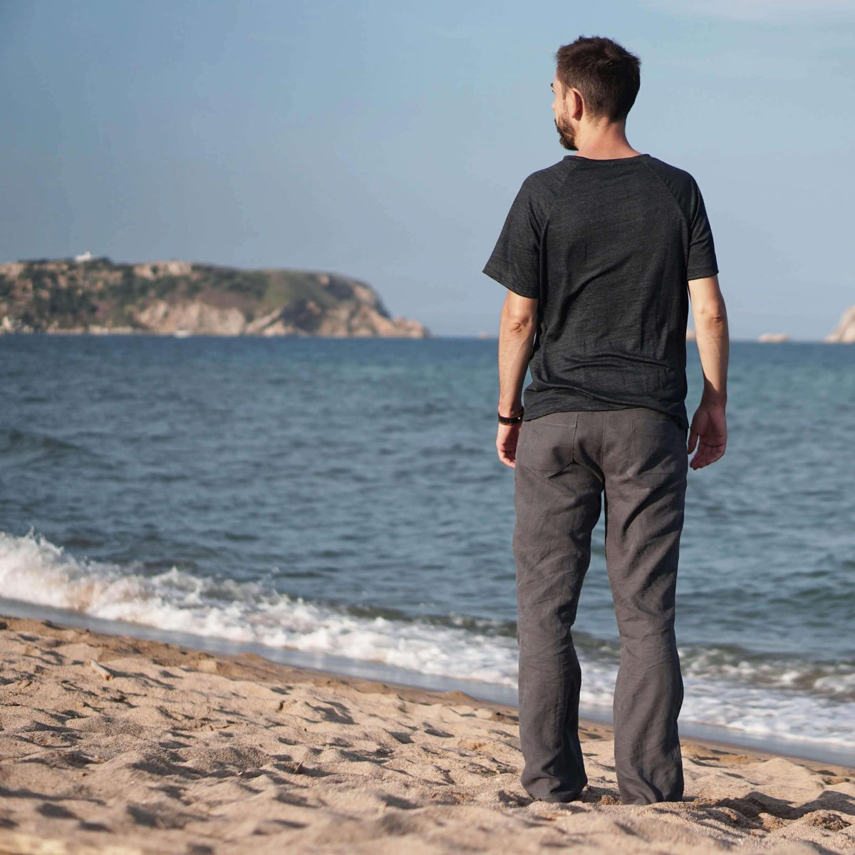 Man standing on the beach wearing summer pants, showcasing the Summer pants paper pattern.