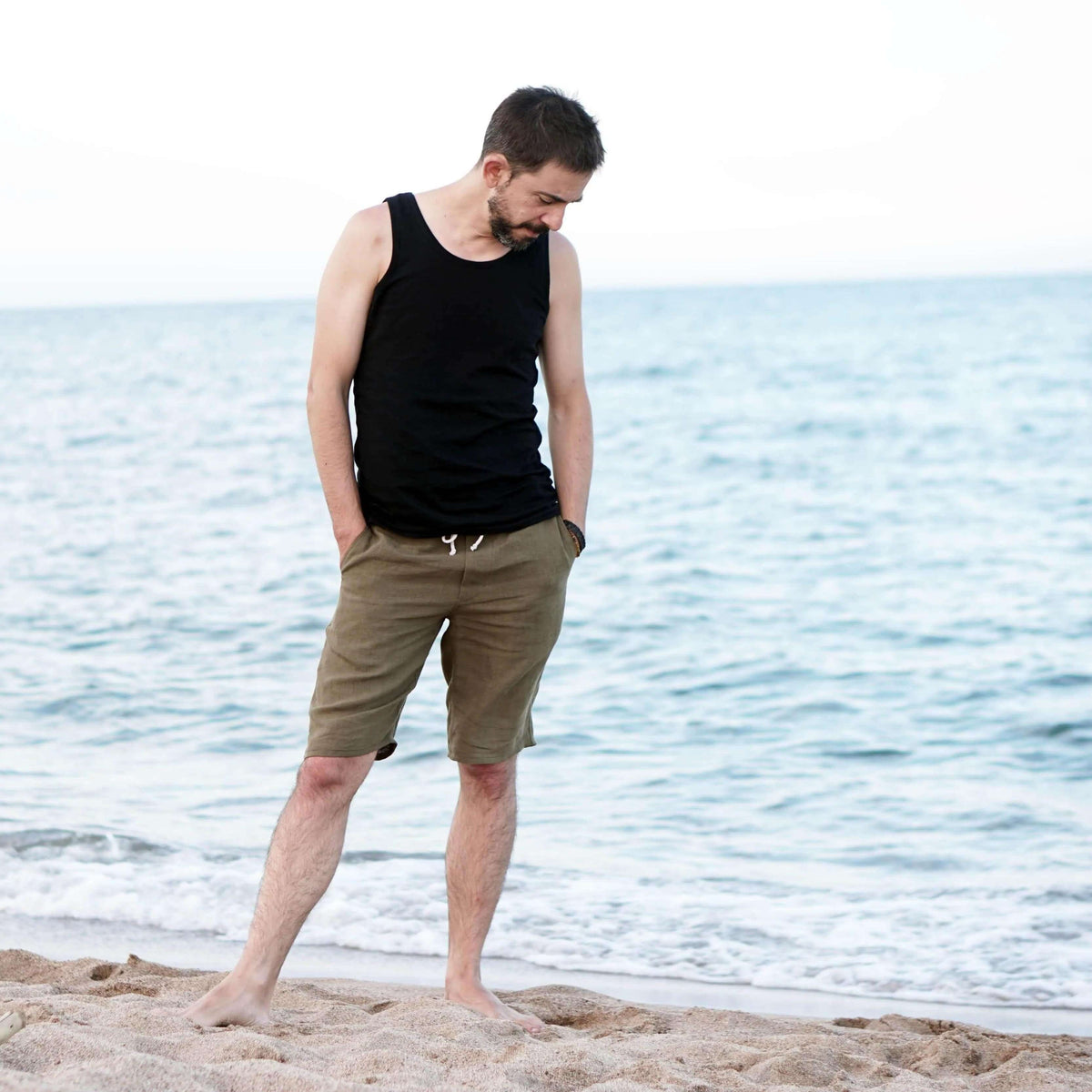 Man wearing casual summer outfit by the beach, showcasing the Summer pants paper pattern style.