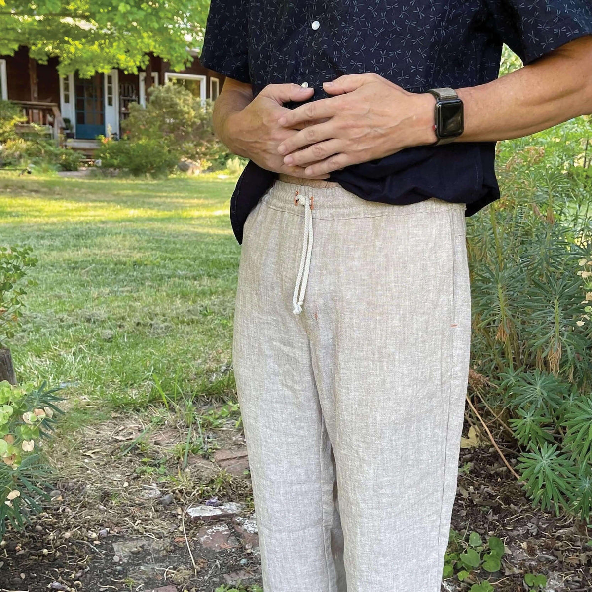 Close-up of a man wearing light-colored summer pants, showcasing the elastic waistband and drawstring, Summer pants paper pattern.