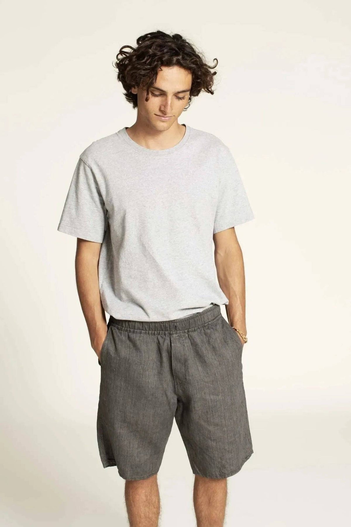 Model wearing Men's Summer pants paper pattern with relaxed fit and elastic waistband.