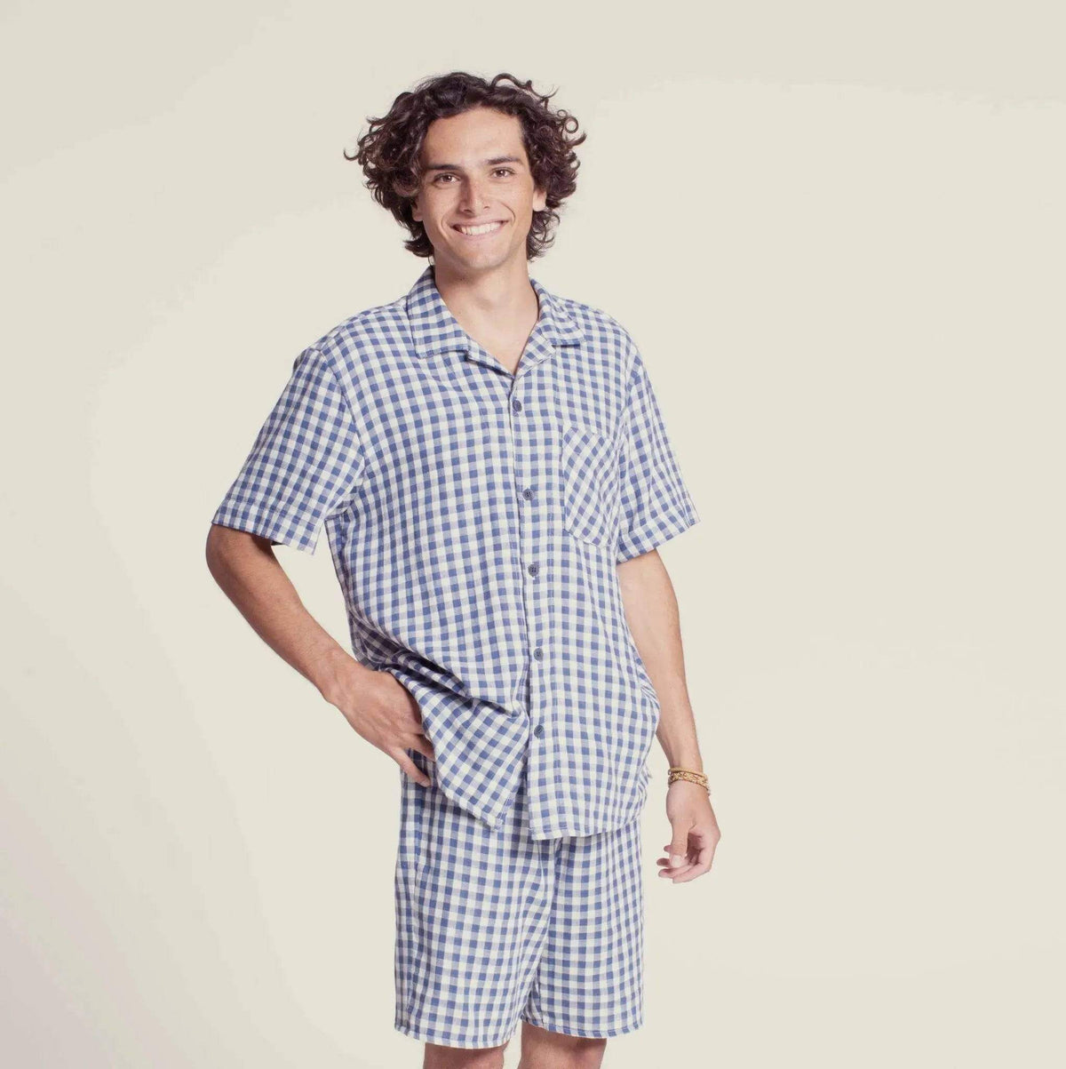 Model wearing a tropical shirt paper pattern in a casual checkered design.