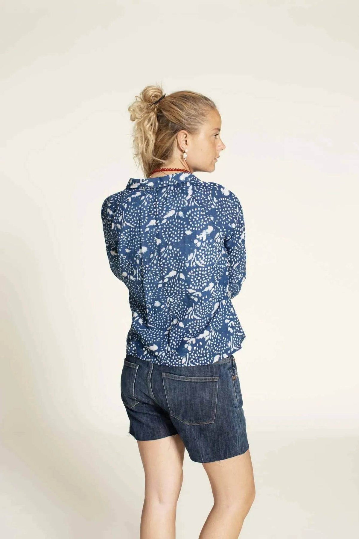 Woman wearing the Tropicana Shirt Paper Pattern from the back, showcasing its relaxed fit and stylish design.