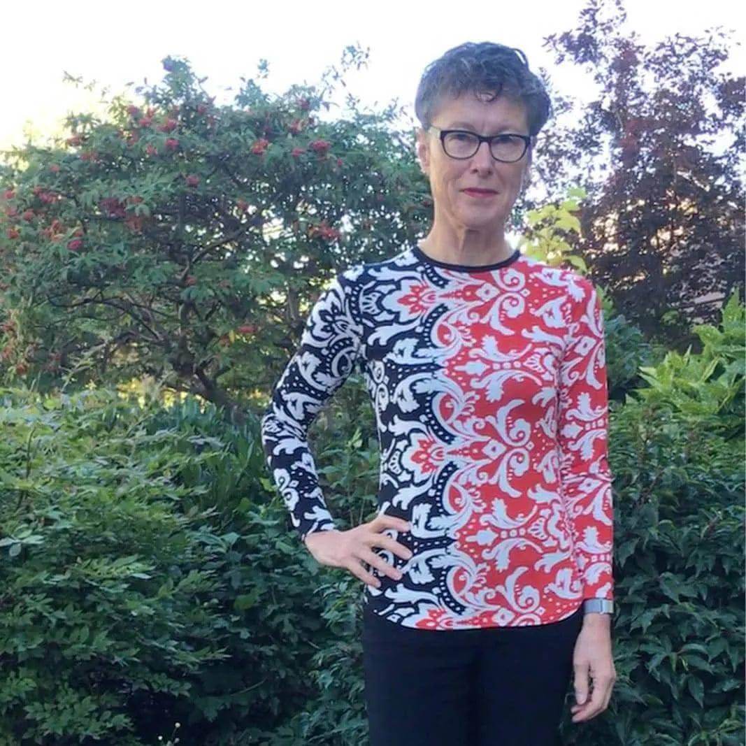 Model wearing a fitted T-shirt made from T-shirt Paper Pattern, featuring a colorful paisley design.