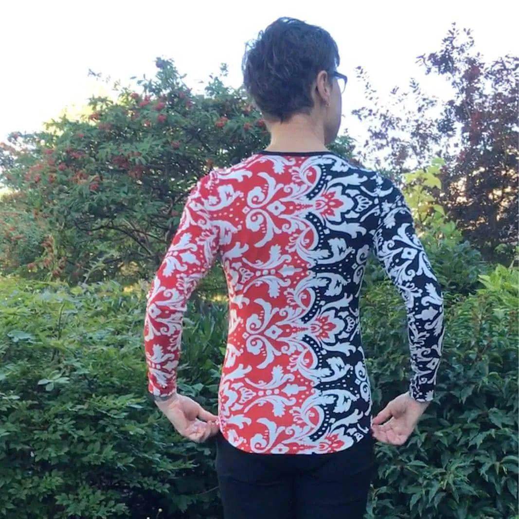 T-shirt Paper Pattern showcased on a model wearing a fitted long-sleeve T-shirt with a vibrant red and black design.