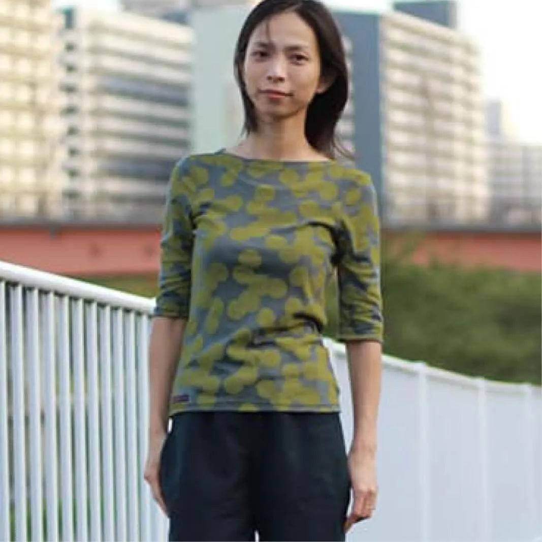 Woman wearing a fitted T-shirt made with T-shirt Paper Pattern, featuring a green camouflage design.