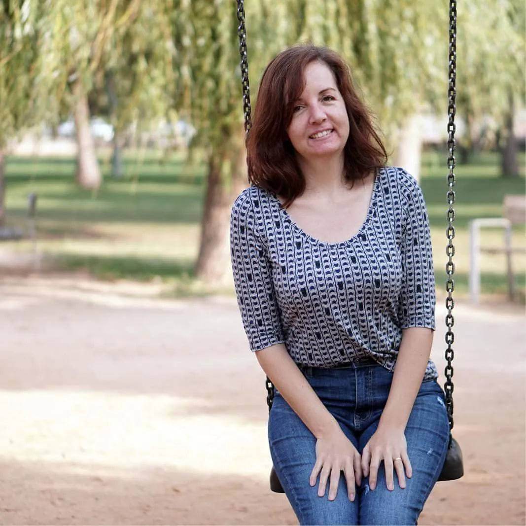 Woman sitting on a swing wearing a fitted T-shirt made with the T-shirt Paper Pattern.