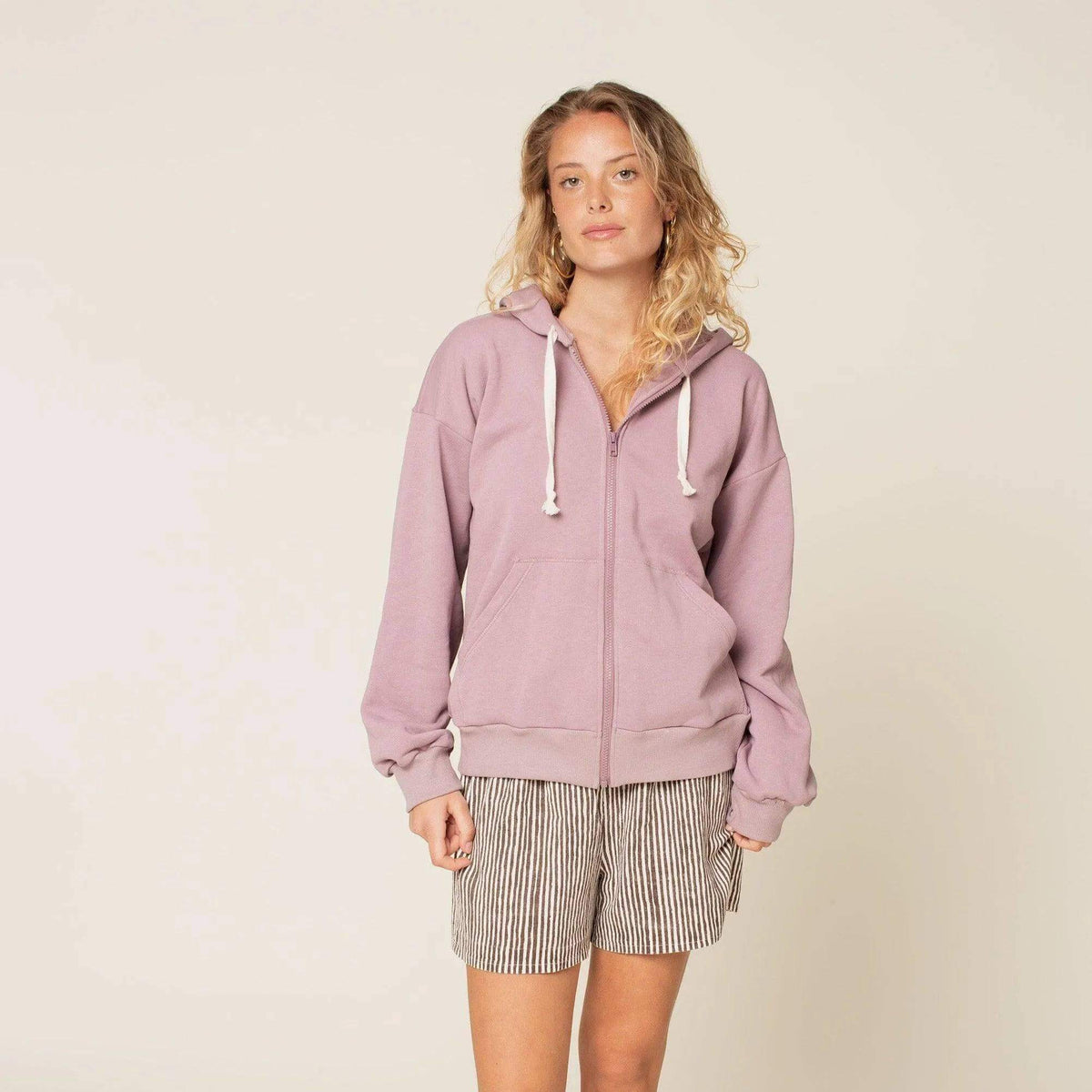 Zipper hoodie paper pattern on a model wearing a lilac zip hoodie with relaxed fit and lined hood.