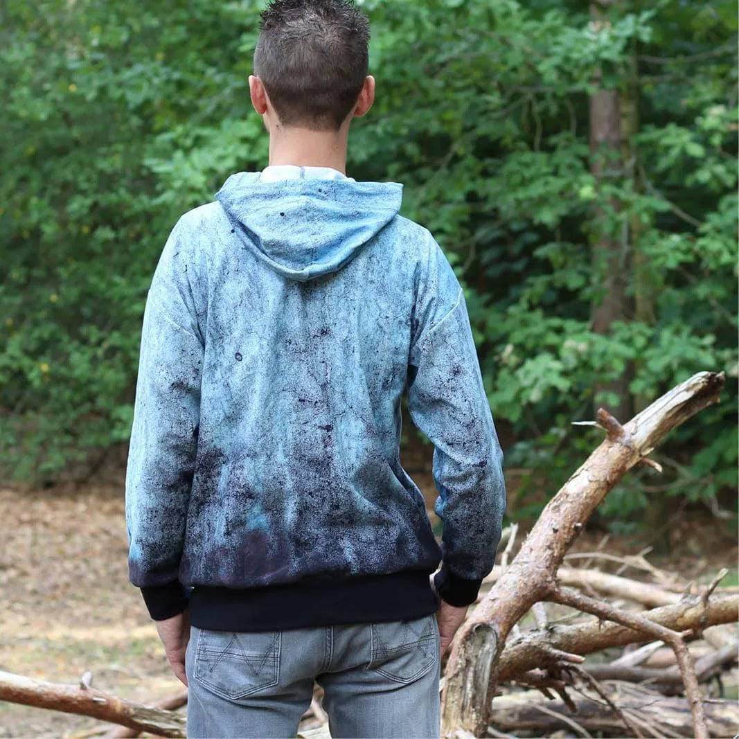 Zipper hoodie paper pattern worn by a man in nature, showcasing its relaxed fit and hood design.