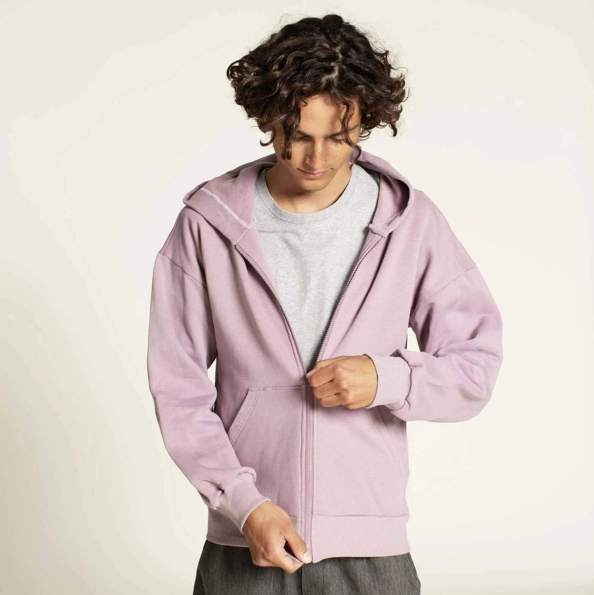 Zipper hoodie paper pattern worn by a man in a relaxed fit, showcasing the stylish light purple color and full-length zipper.